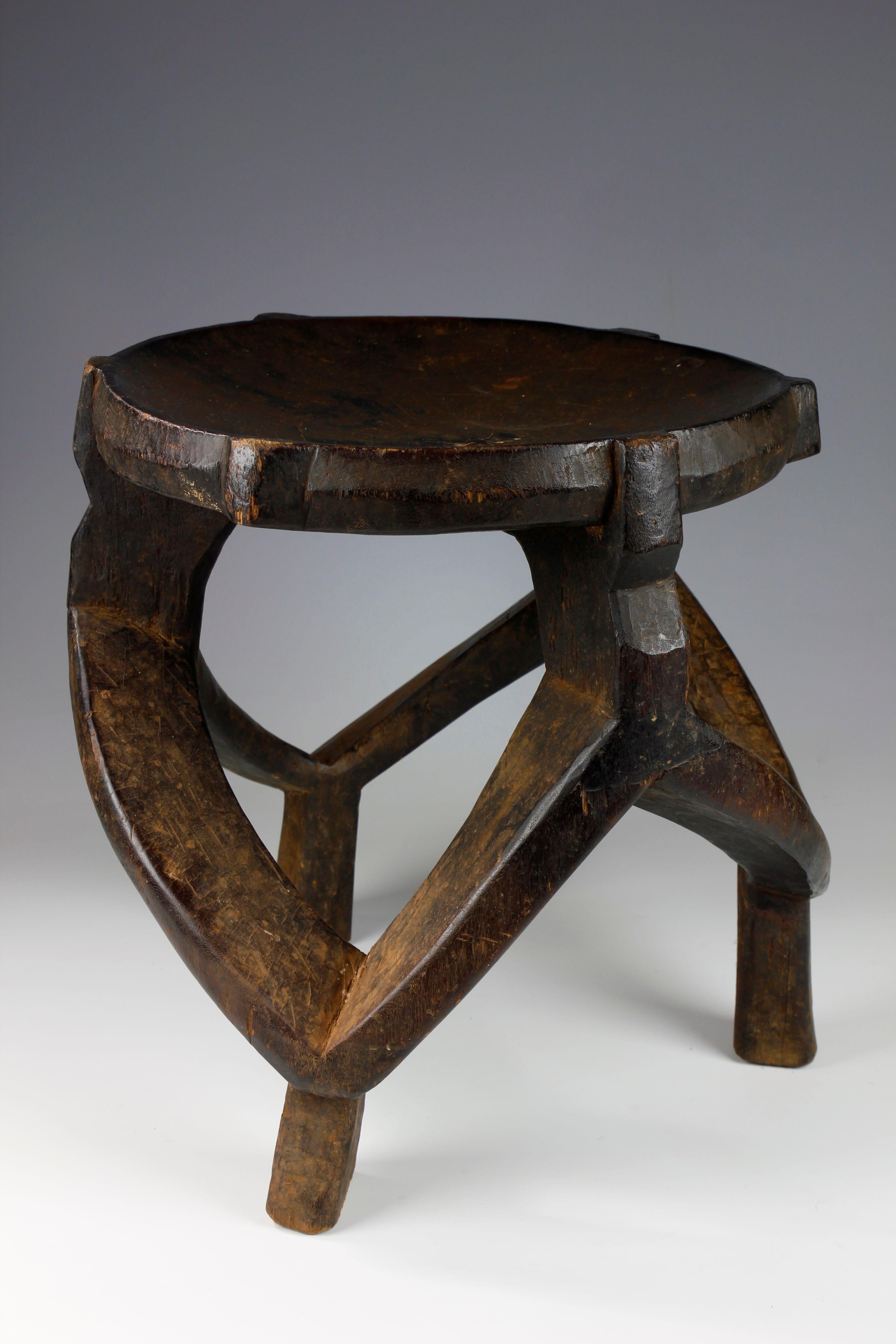 This beautifully carved title stool, from the Gogo culture in Tanzania, features a wonderful looped and adjoining structure. Dating back to the mid-twentieth century, this fine example of a Tanzanian chieftain's stool exhibits a deep, dark surface