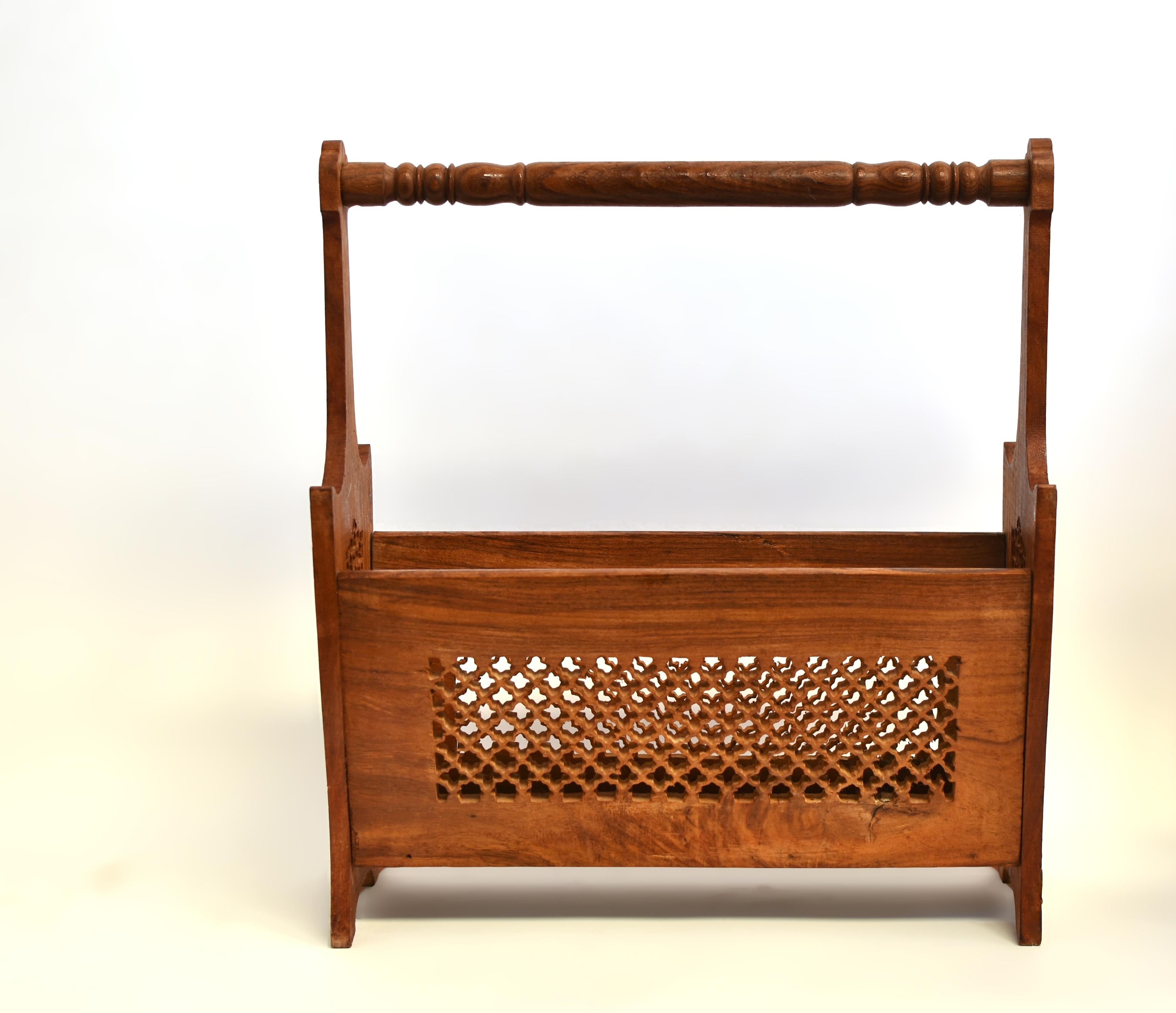 A beautiful solid wood magazine rack, handcrafted from rich solid teak wood. Finely carved on all 4 sides with intricate patterns of stars, beehives, and cloves, it showcases both artistry and function. The round handle provides comfort and ease