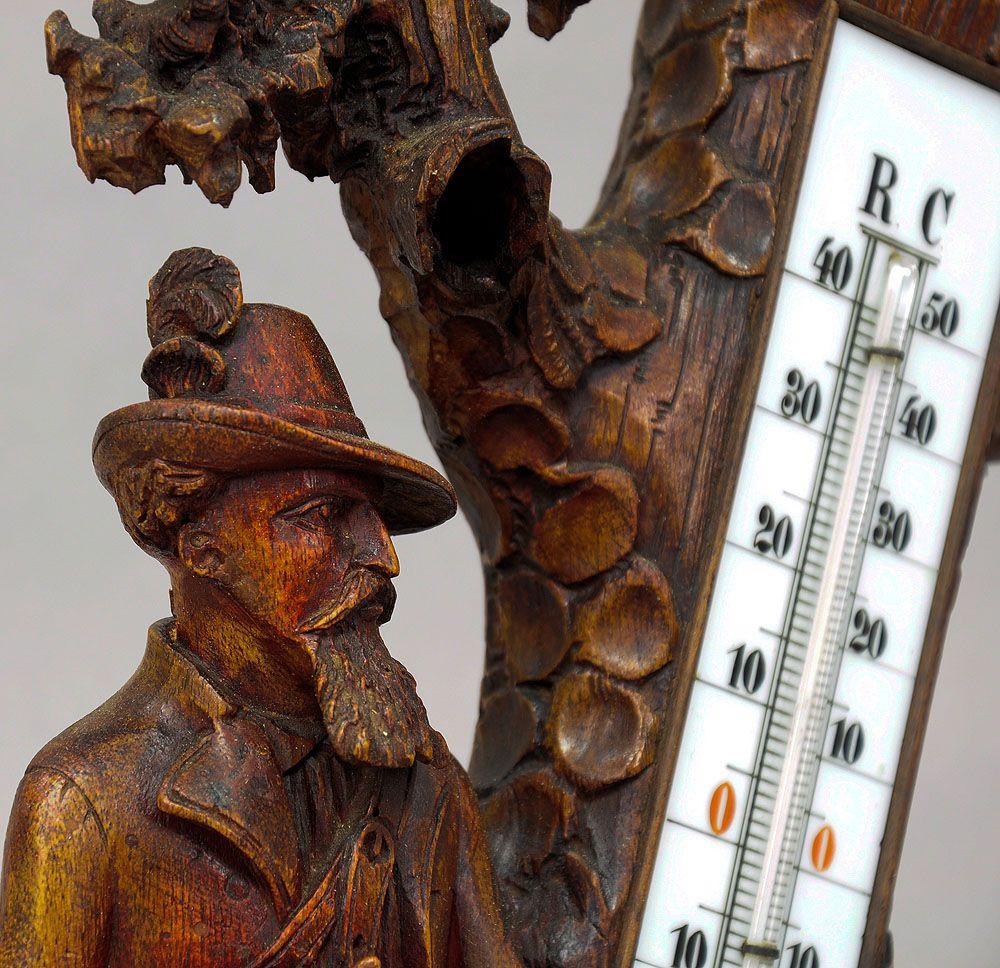 Finely Carved Wood Thermometer Stand Hunter and Staghound, 1910

A Black Forest thermometer with impressive carved hunter and staghound standing on a naturalistic carved base by a stump. The sculpture was executed in Austria ca. 1910. Some old