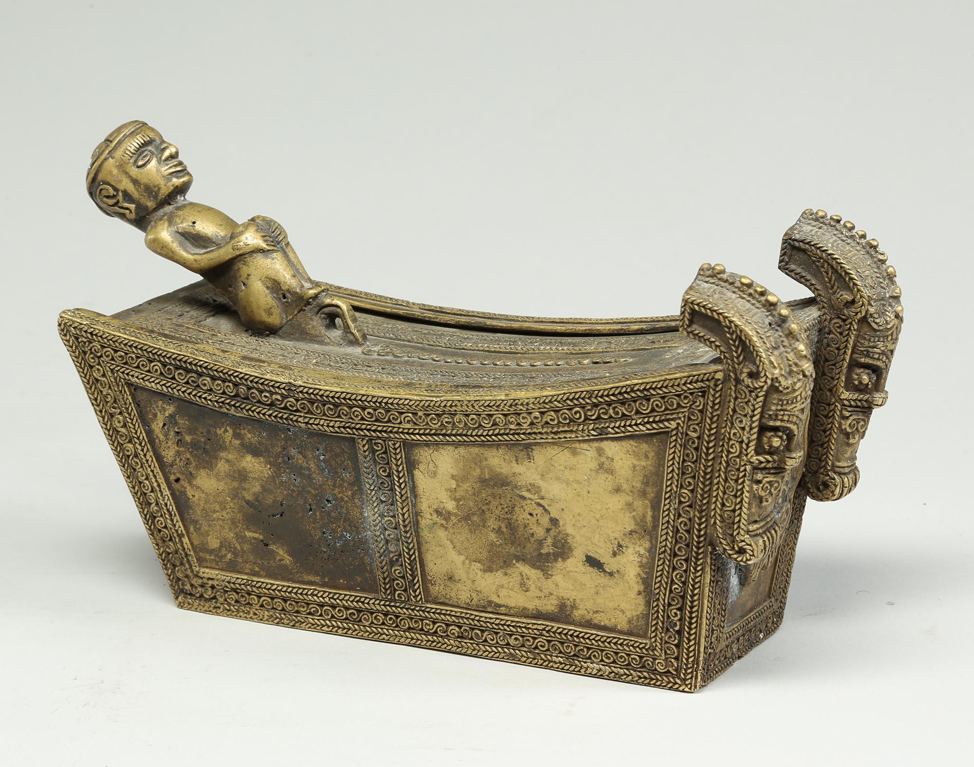 Extremely finely crafted, probably made by the lost wax process, cast bronze small Batak storage box with reclining figure with hands on knees and two protective singas at one end. In the form of a Batak coffin with lots of fine cast designs, early