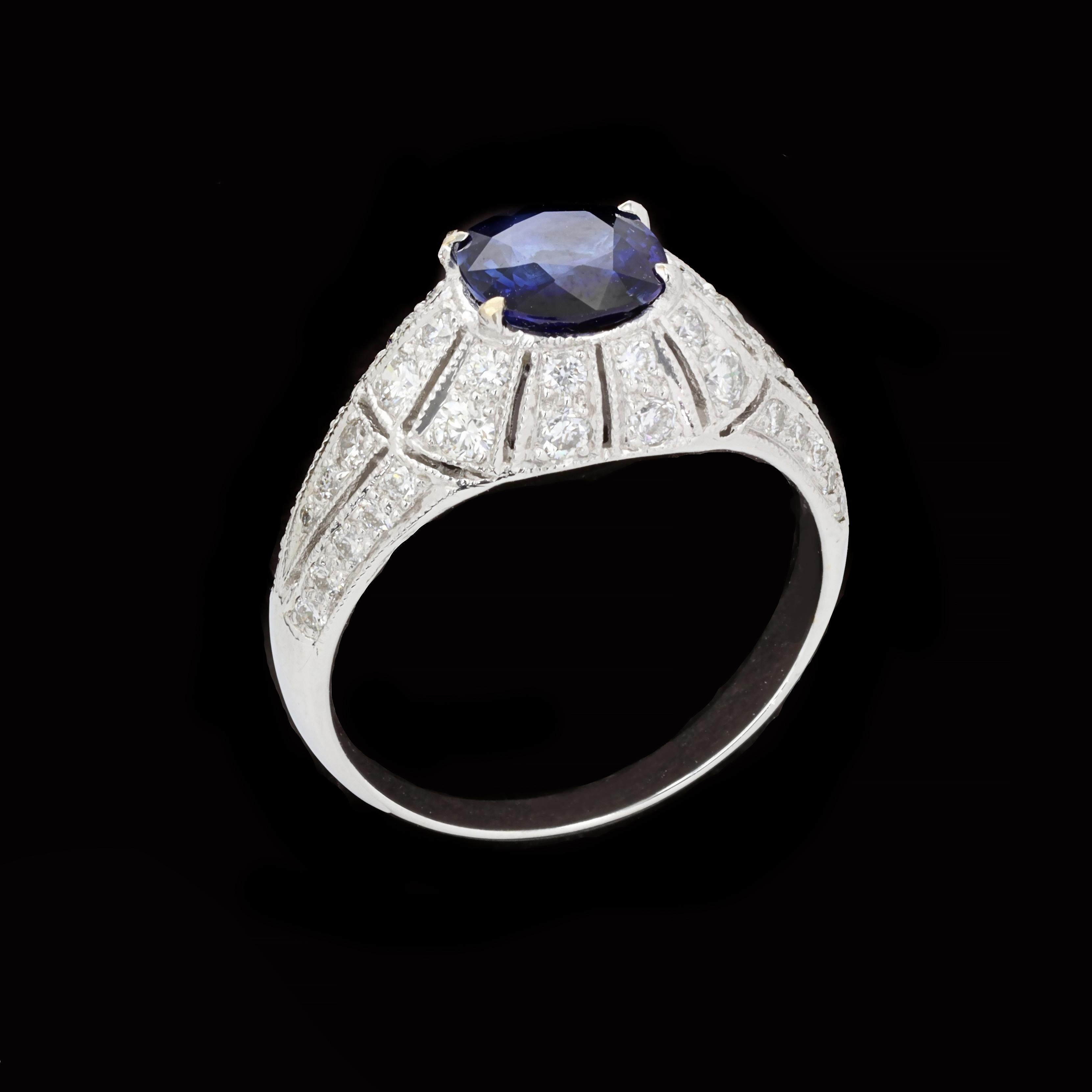 Understated elegance in an exceptional package. This charming ring is centered with a cushion cut sapphire that weighs approximately 0.90ct and has 44 round cut diamonds that weigh approximately 0.50ct. The setting has a raised dome effect with