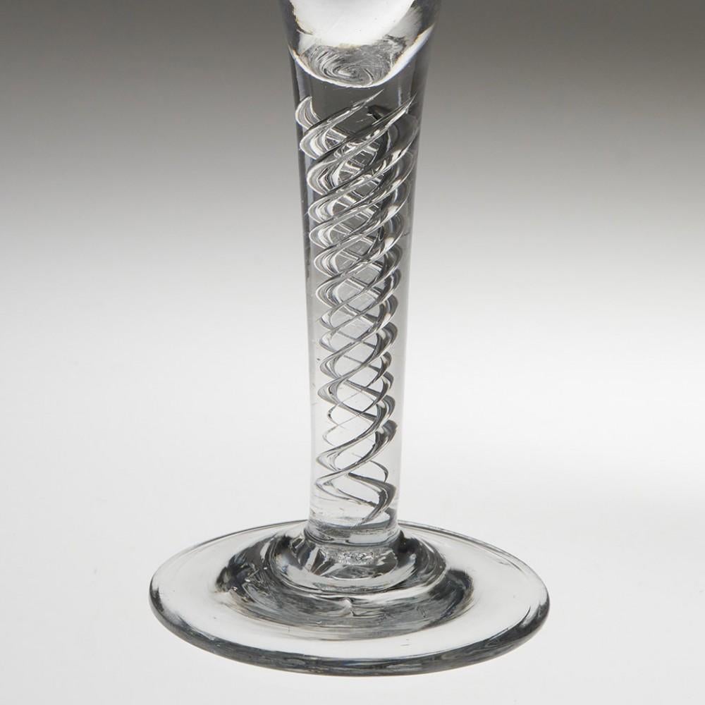 Heading : Finely Engraved Air Twist Stem Wine Glass
Period : George II c1750
Origin : England
Colour : Clear, excellent grey tone
Bowl : Drawn trumpet engraved for vine leaves, tendrils and polished grapes
Stem : Four ait spirals
Foot :