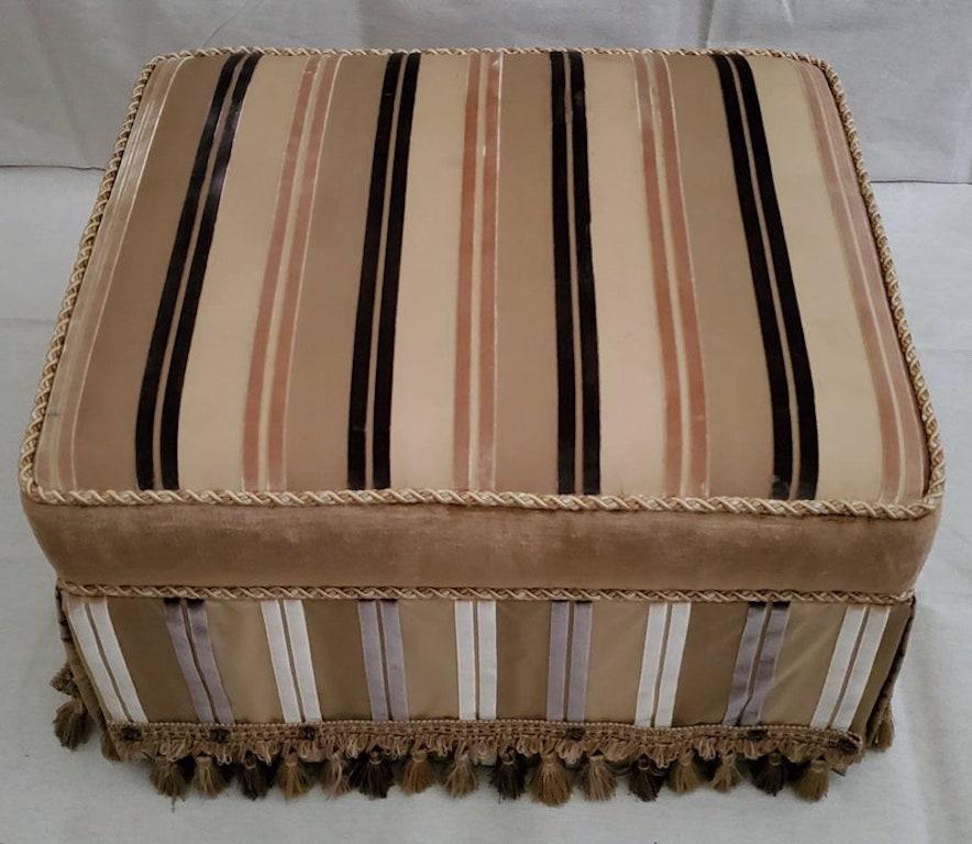 A fine classically inspired custom contemporary ottoman. Luxuriously hand-upholstered, using various fabrics, and a tassel fringe base. Rectangular in shape. This finely detailed and wonderfully decorative ottoman will bring a touch of elegance to