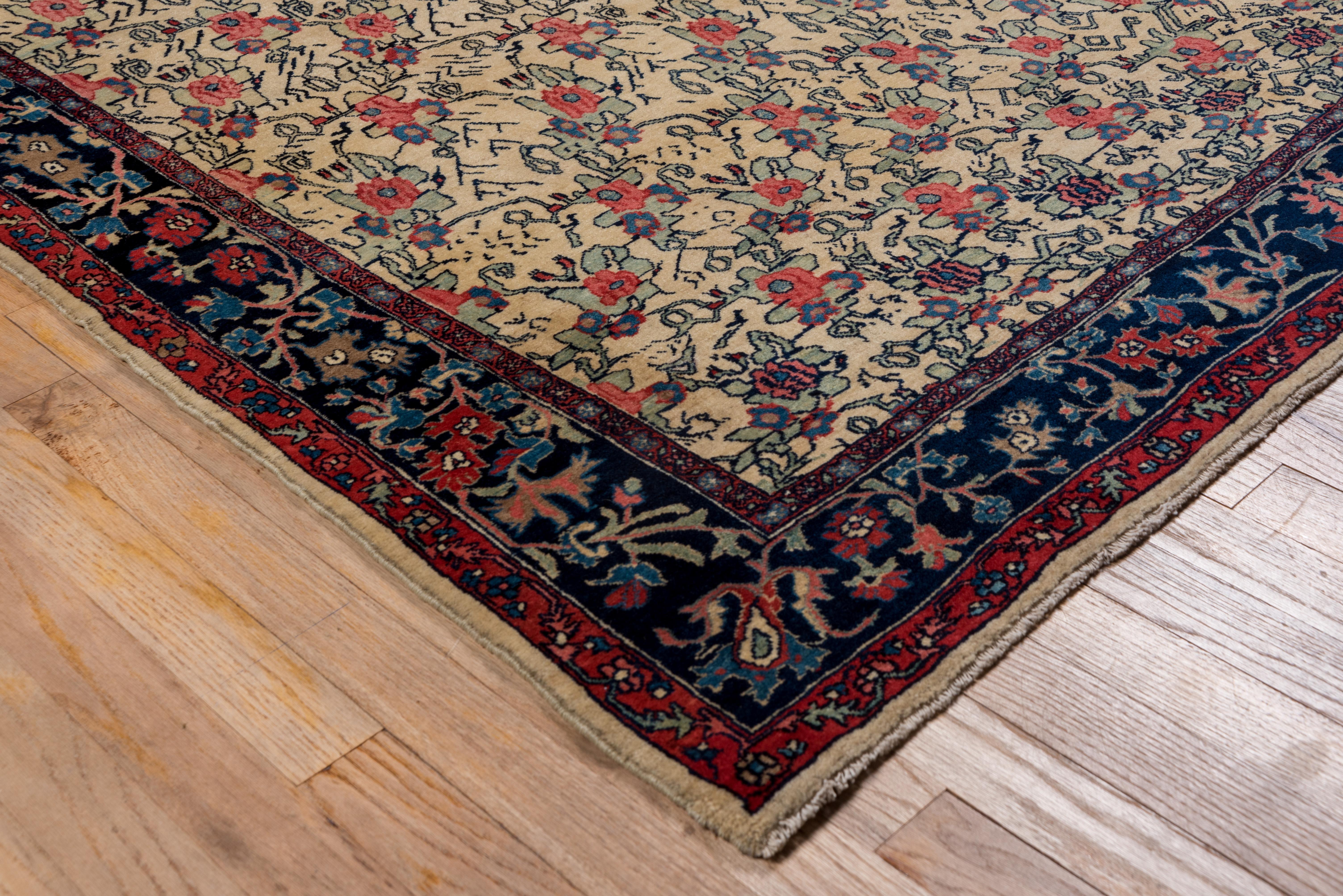 This very solidly woven Kurdistan urban scatter displays an ivory ground with stylized rose bunches that progressively move apart and geometries as one moves up the rug. The navy border displays bud, small flowers and branching vines. Great
