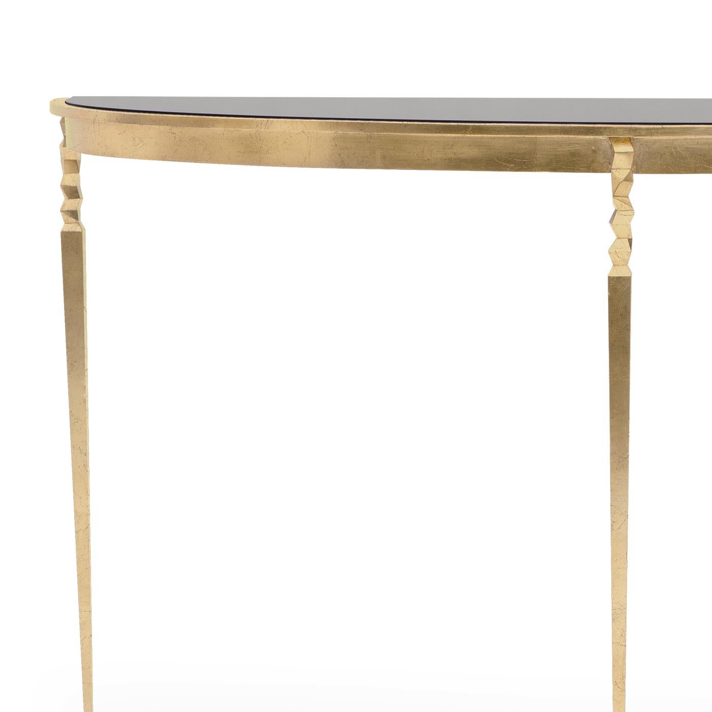 Console table finesse with solid black glass top.
On forged iron base in gold finish style oro.
Base also available in others finishes on request.