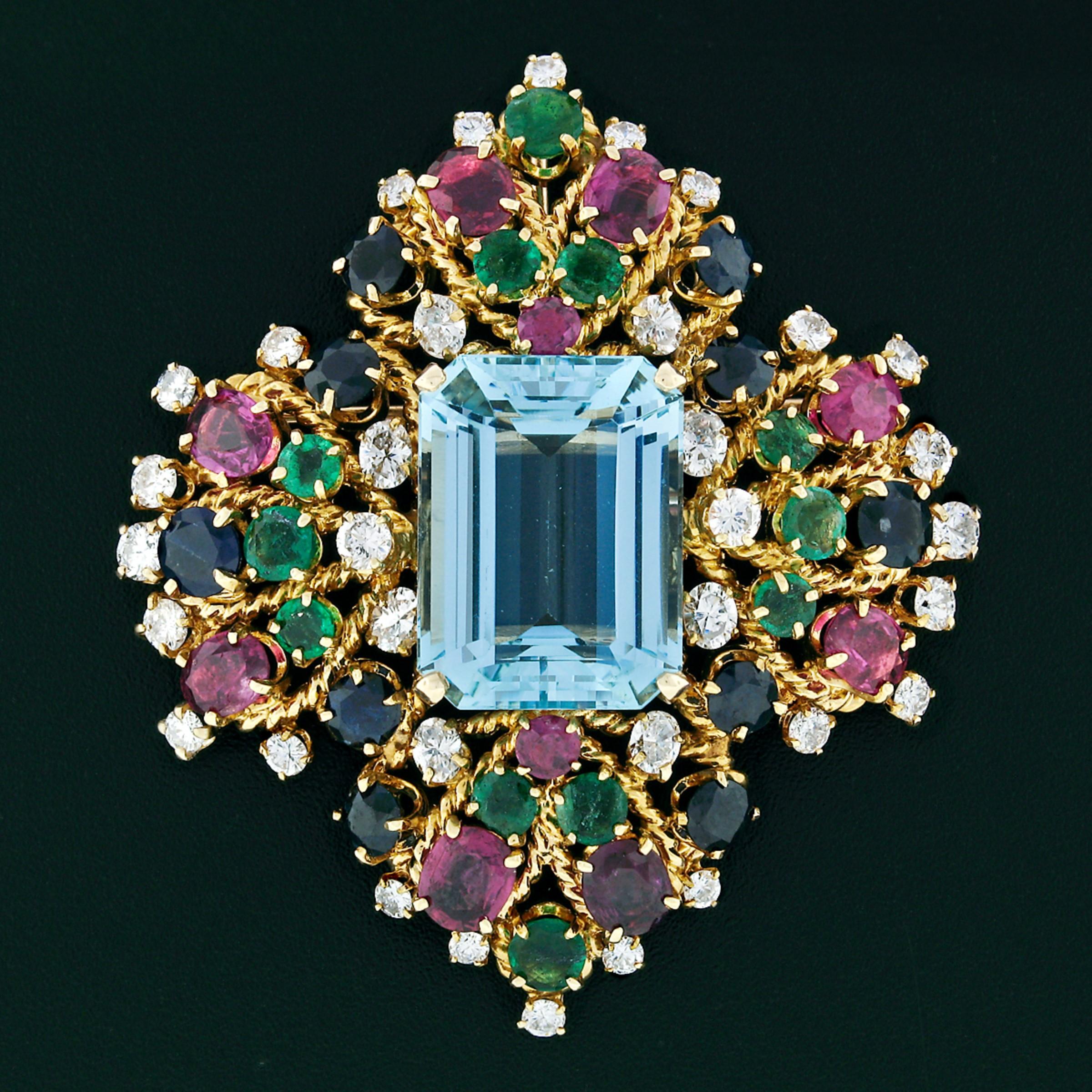 Here we have an absolutely magnificent vintage statement brooch which was hand-crafted from solid 18k yellow gold. This fancy brooch features a gorgeous, GIA certified, large and rich blue aquamarine stone sitting at the center of the brooch. The