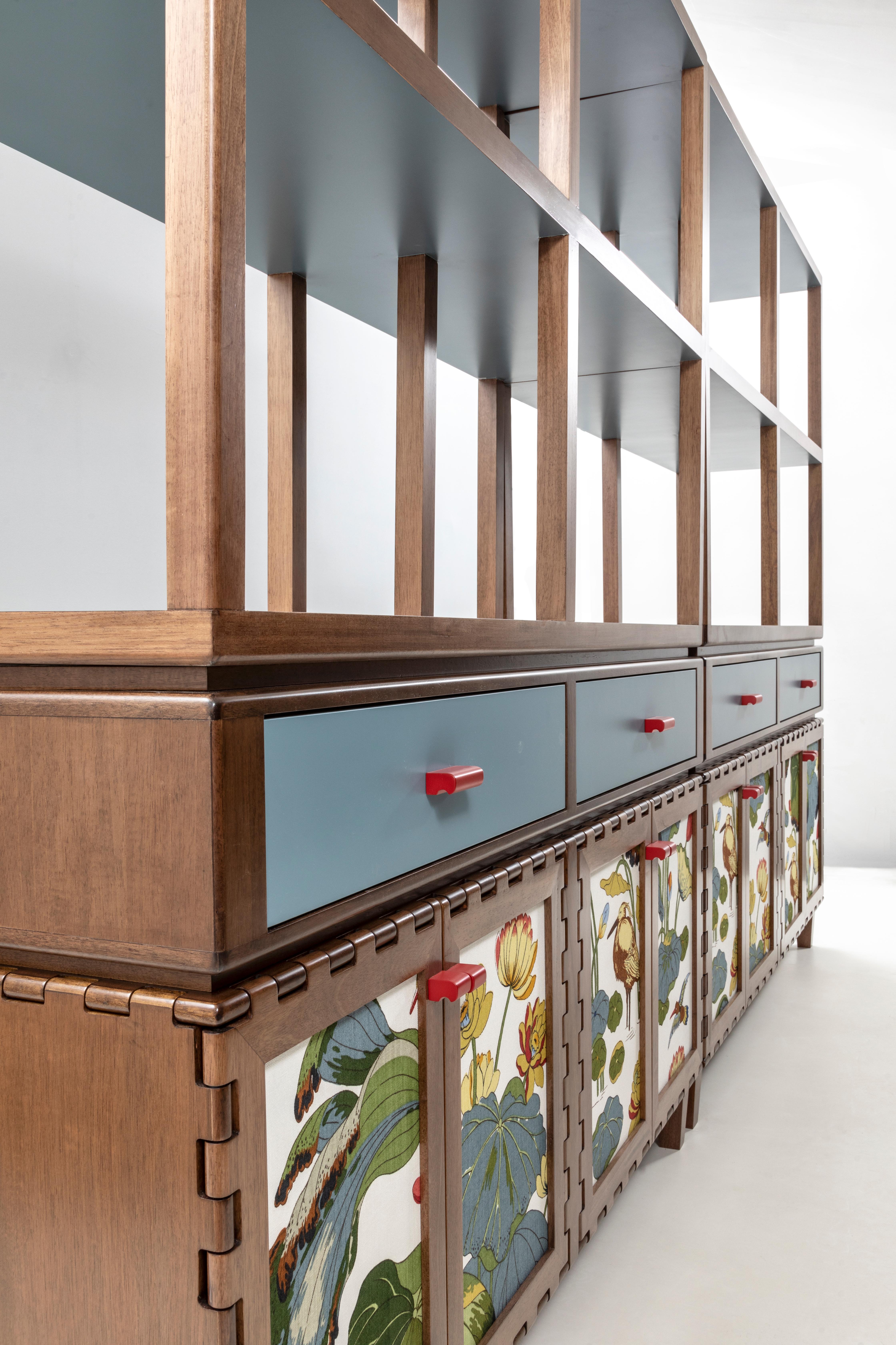 Handcrafted sideboard cabinet in wood with Joseph Frank fabric insert. The wood highlights the simplicity of the hinged frame design details. The piece comes with drawers on top and a shelving system as accessory, turning the piece into a functional