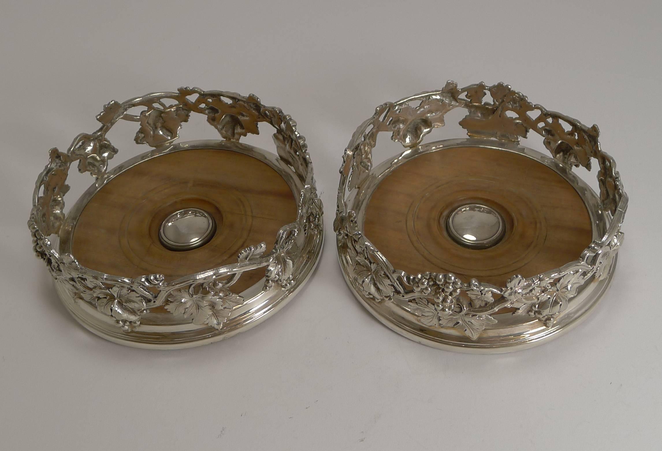 A magnificent set of early Victorian Elkington silver plate wine coasters, with an attractive cast grape vine design with lovely detail. The coasters have turned wooden bases, with a central silver plate boss without engraving.

Both coasters