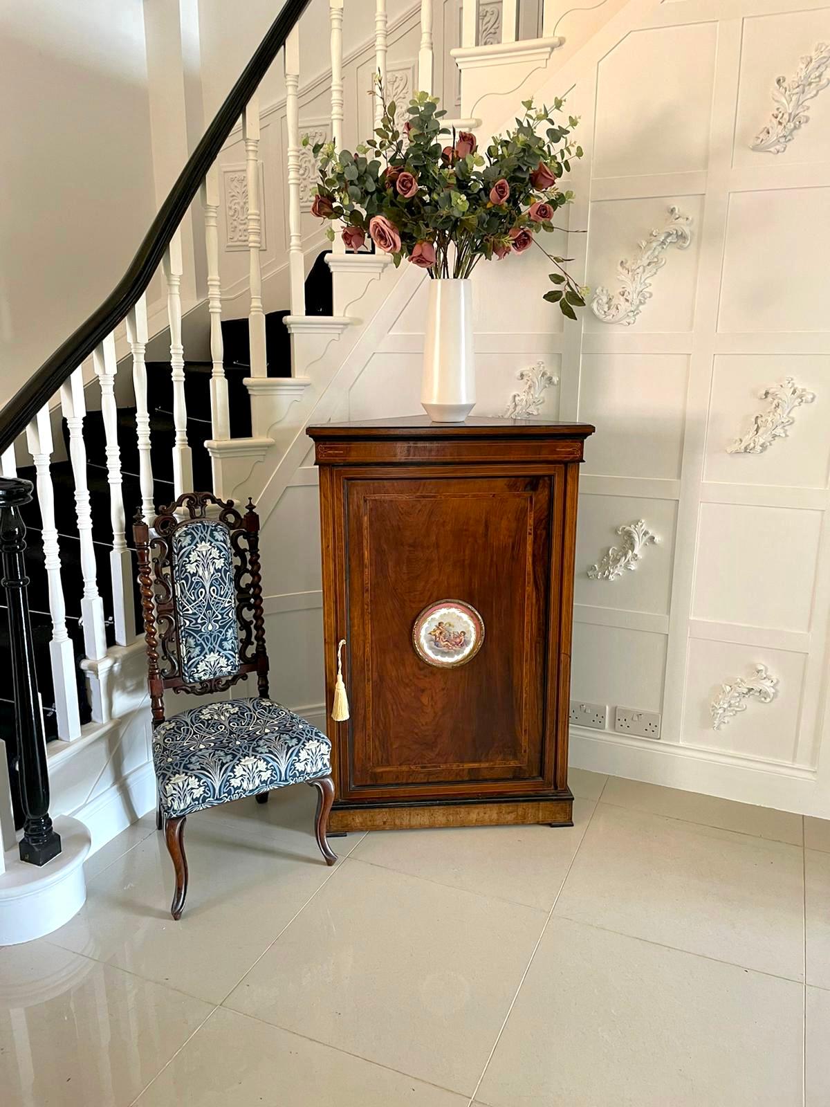 Finest quality 19th Century Victorian antique inlaid walnut corner cabinet having a superb walnut inlaid top and frieze. The door is crossbanded with an exquisite central Sevres style porcelain plaque in an ormolu surround. It stands on a plinth