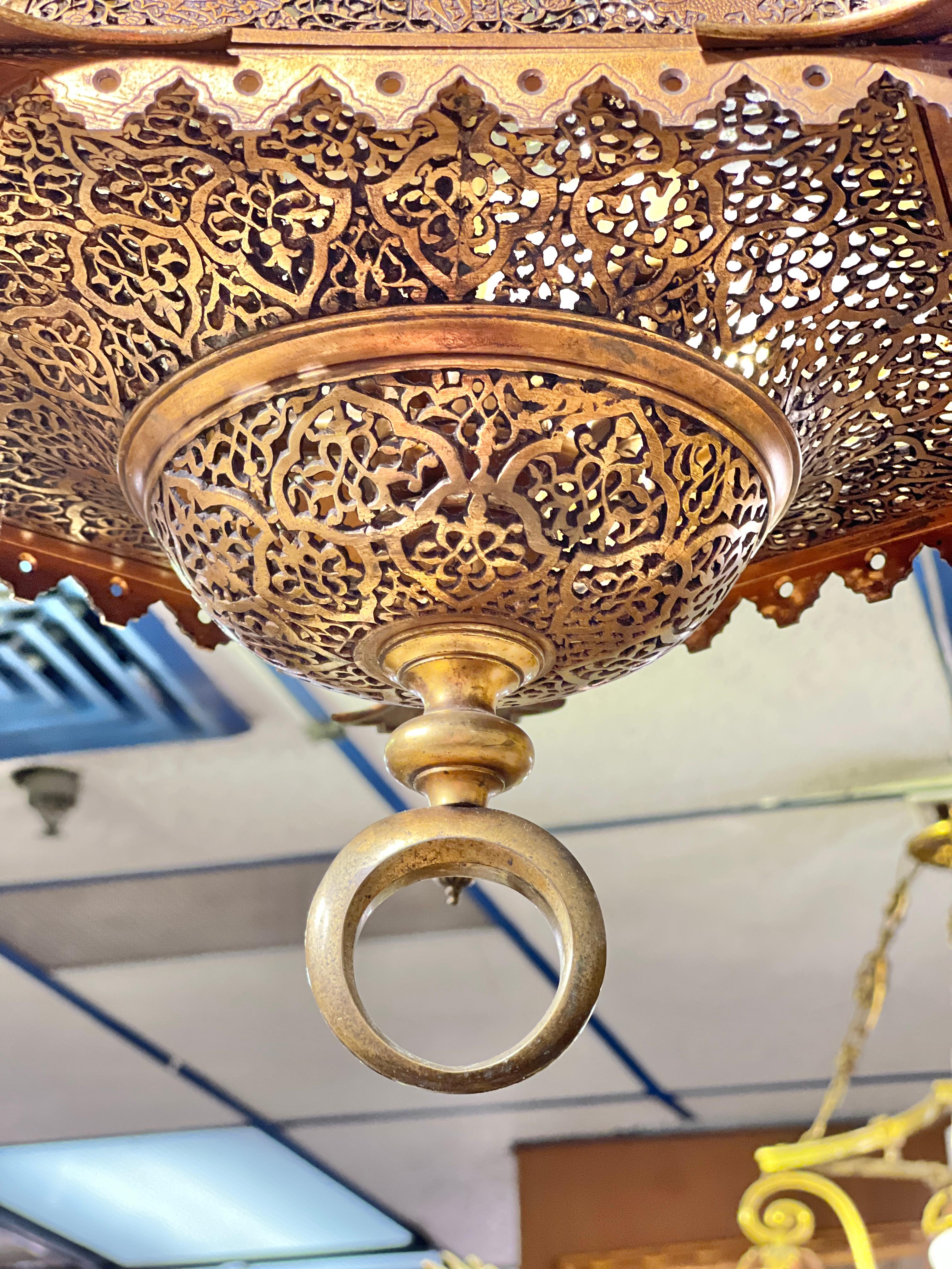 Finest quality French antique hexagonal shaped Bronze  lantern form chandelier in the Persian/ Middle eastern  style with five candelabra size sockets and faux wax candle covers, distinguished by its openwork and reticulated panels depicting figures