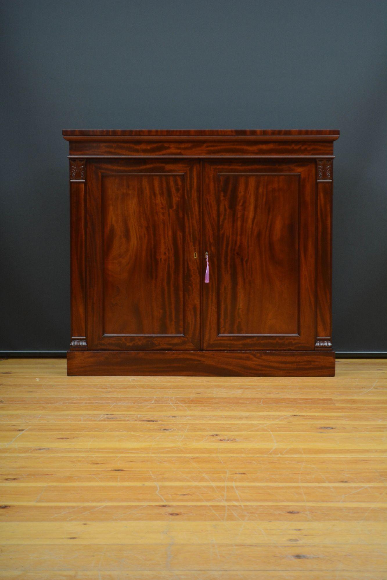 Sn5652 Finest quality English antique William IV two door mahogany sideboard, having well figured mahogany top above a shallow frieze and a pair of well figured panelled cupboard doors, enclosing two drawers ( one fitted with compartments ) and a