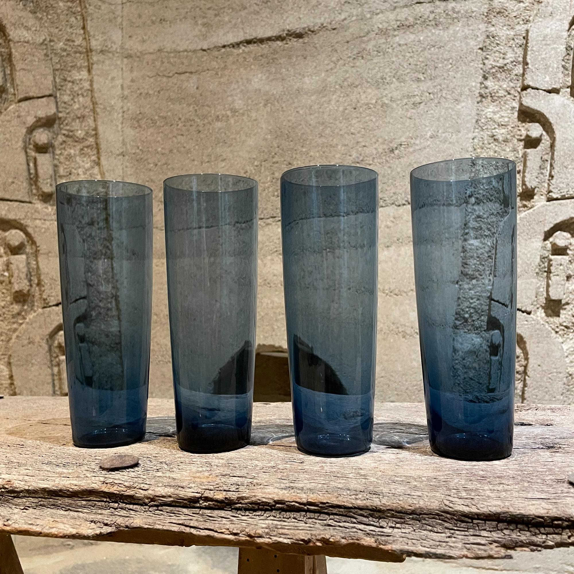 For you: Modern Set of four tall narrow tumbler glasses in blue made in Finland by Iittala.
Designer Kaj Franck
Scandinavian Art Glass
One glass retains maker label. Preowned and in good condition.
Measures: 7T x 2.5 diameter inches
Refer to