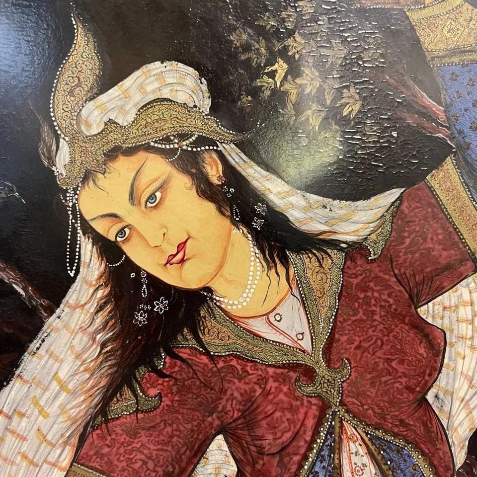 Beautiful old Persian School group portrait, apparently oil on board, depicting princess pouring wine for two elderly scholars, one holding the Koran and with a Kamancheh instrument at their feet.  Apparently dating from the mid-twentieth century,