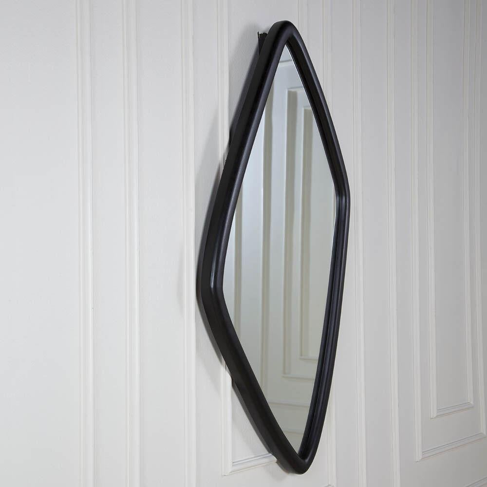 With its amorphous walnut frame, in both Natural and Ebonized finishes, the Finley Mirror is an unexpected organic take on a classic shape. The soft rounded profile of the frame holds a single piece of clear mirror. Hanging hardware is included.
