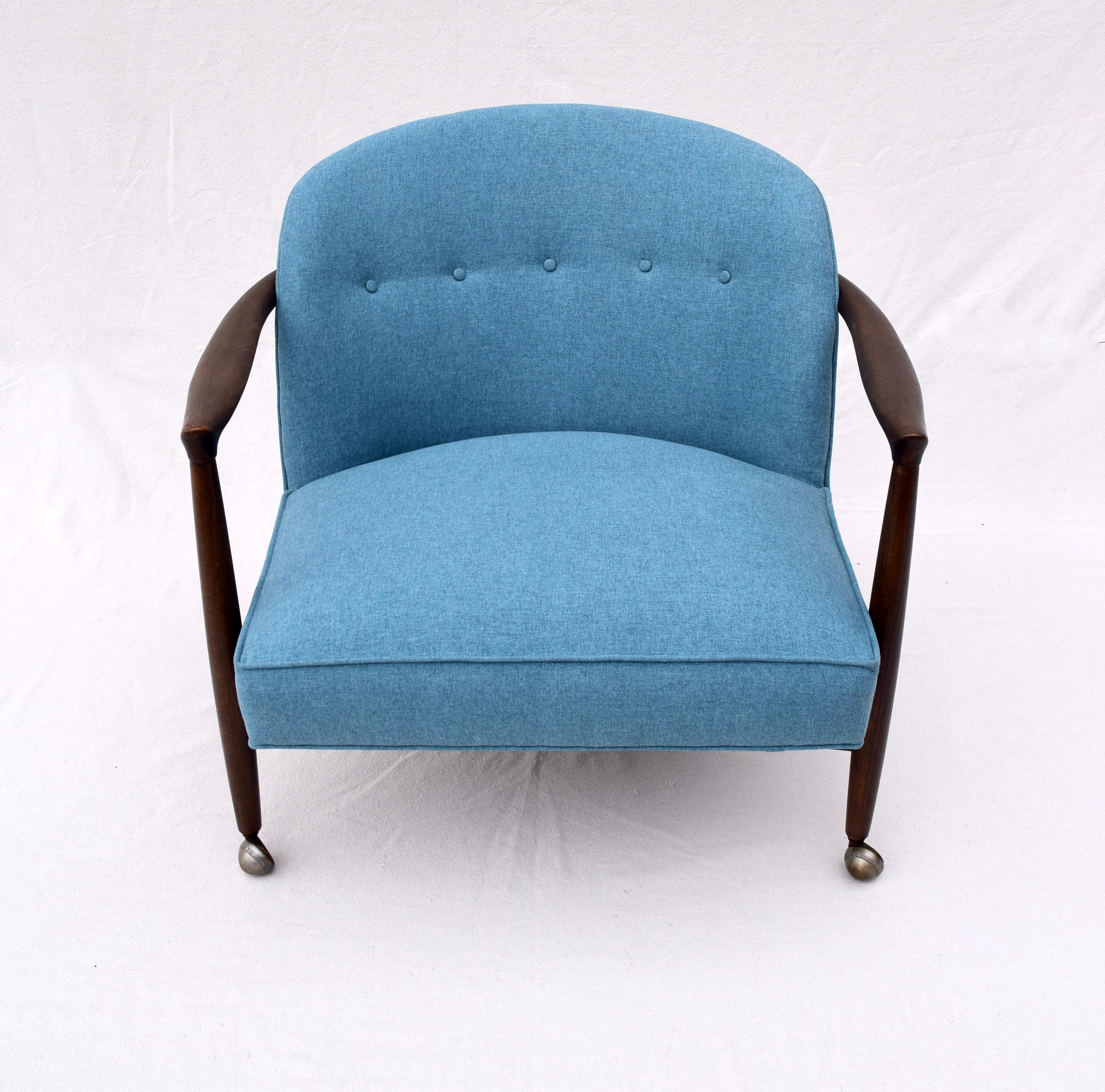 Finn Andersen for Selig Denmark sculpted barrel back lounge chair, circa 1960. Sculpted walnut hand waxed frame with original finish and warm patina upholstered in vibrant blue brushed felt. Original orbit casters on front legs designed for simple