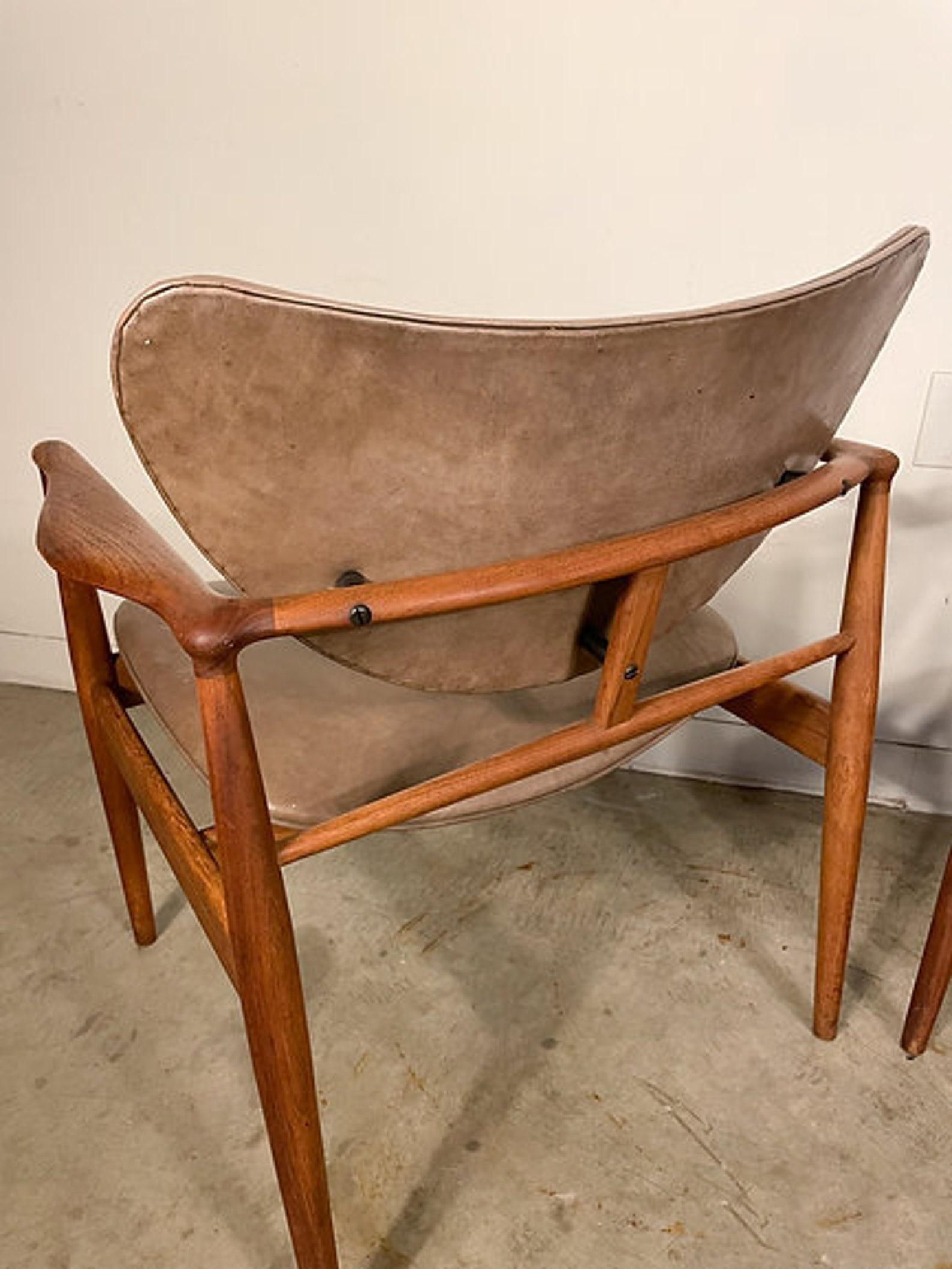 Iconic model 48 chairs were designed by Finn Juhl for Baker's Modern line in 1952. The chairs offer solid walnut frames that are beautifully sculpted and incredibly comfortable with an equally attractive curved seat and back. Original leather