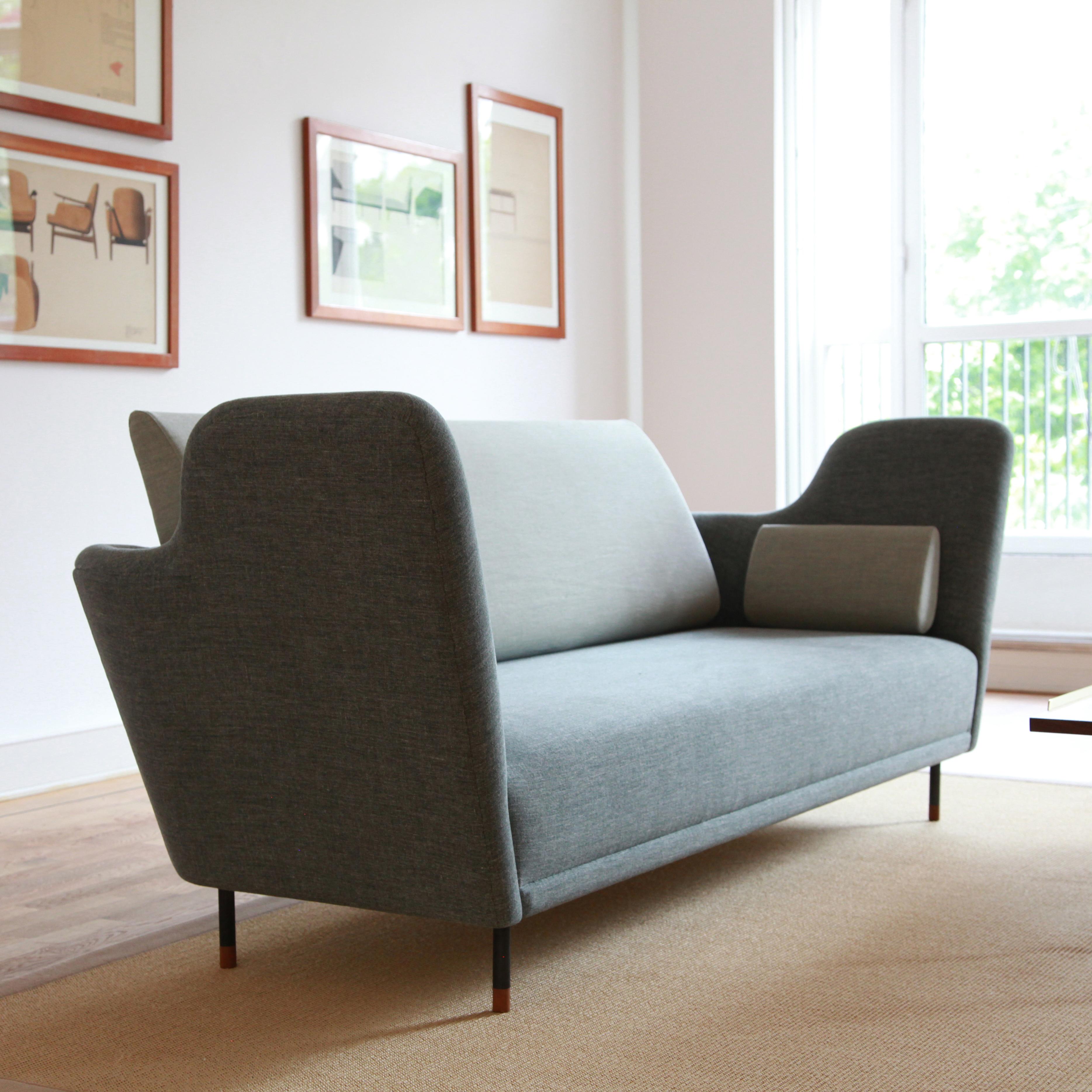 Sofa designed by Finn Juhl in 1957, relaunched in 2000.
Manufactured by House of Finn Juhl in Denmark.

The sofa was exhibited for the very first time in the Tivoli Gardens in Copenhagen during 1957. However, it took more than 40 years before