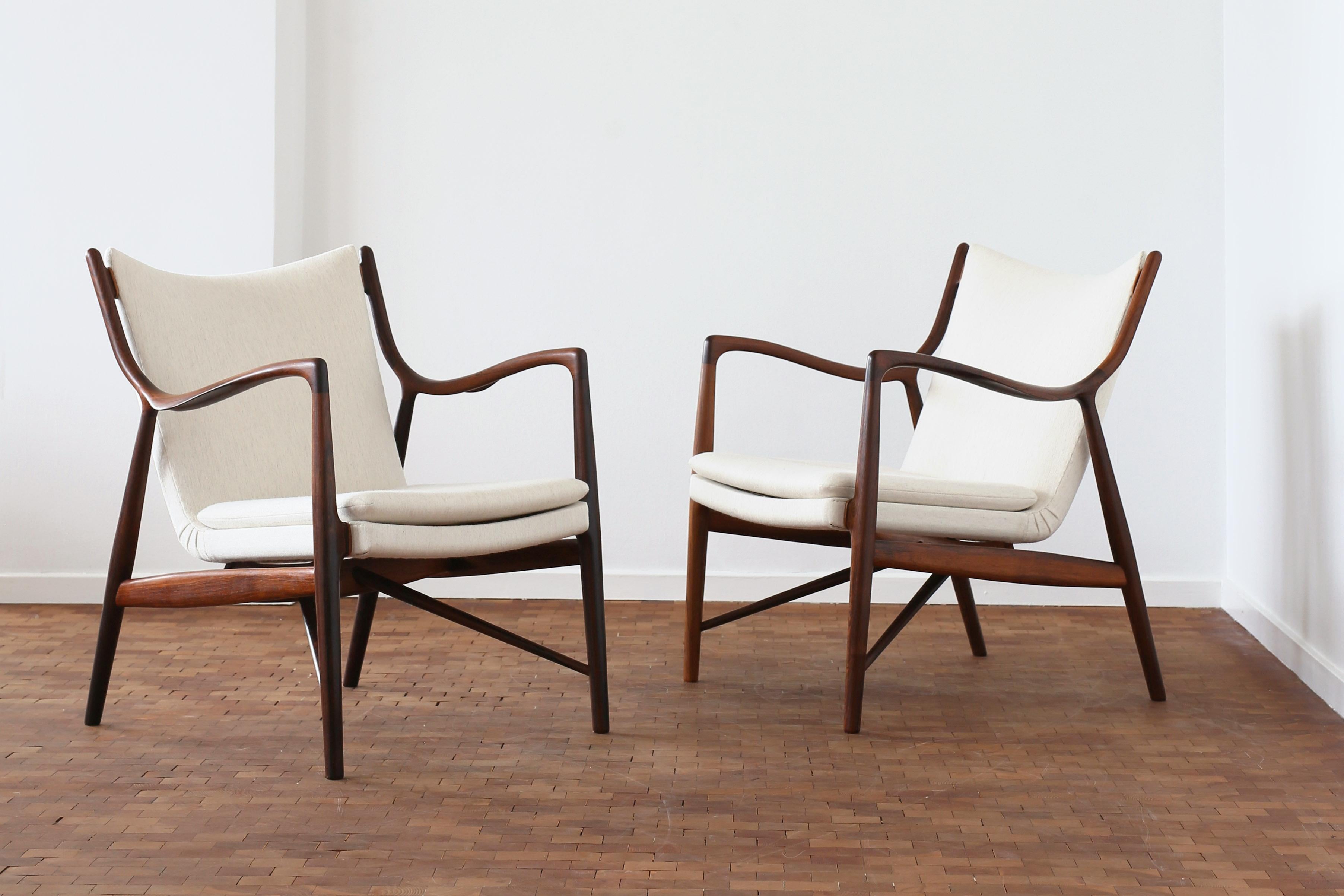 A rare pair of Finn Juhl NV-45 chairs with frame of Brazilian rosewood, upholstered with light fabric. 

Designed 1945 and made at cabinetmaker Niels Vodder. both chairs stamped by Niels Vodder. 
. 
Very fine condition. 
CITES Certificate included. 
