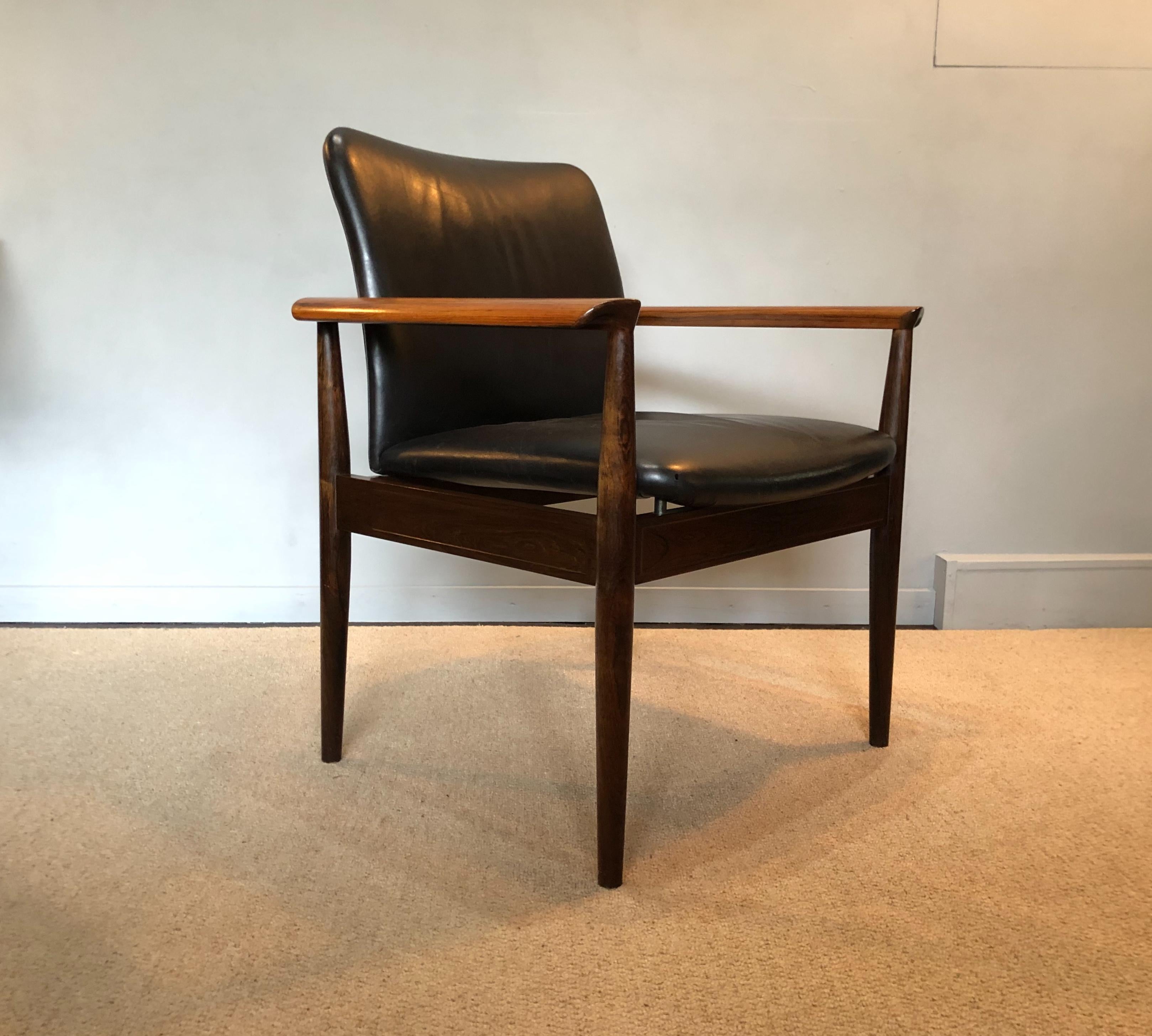 A very fine example of the classic Diplomat chair. Designed by Finn Juhl and manufactured by France and sons. Stunning rosewood frame with original black leather. In wonderful condition throughout. Frame re-polished and leather cleaned and