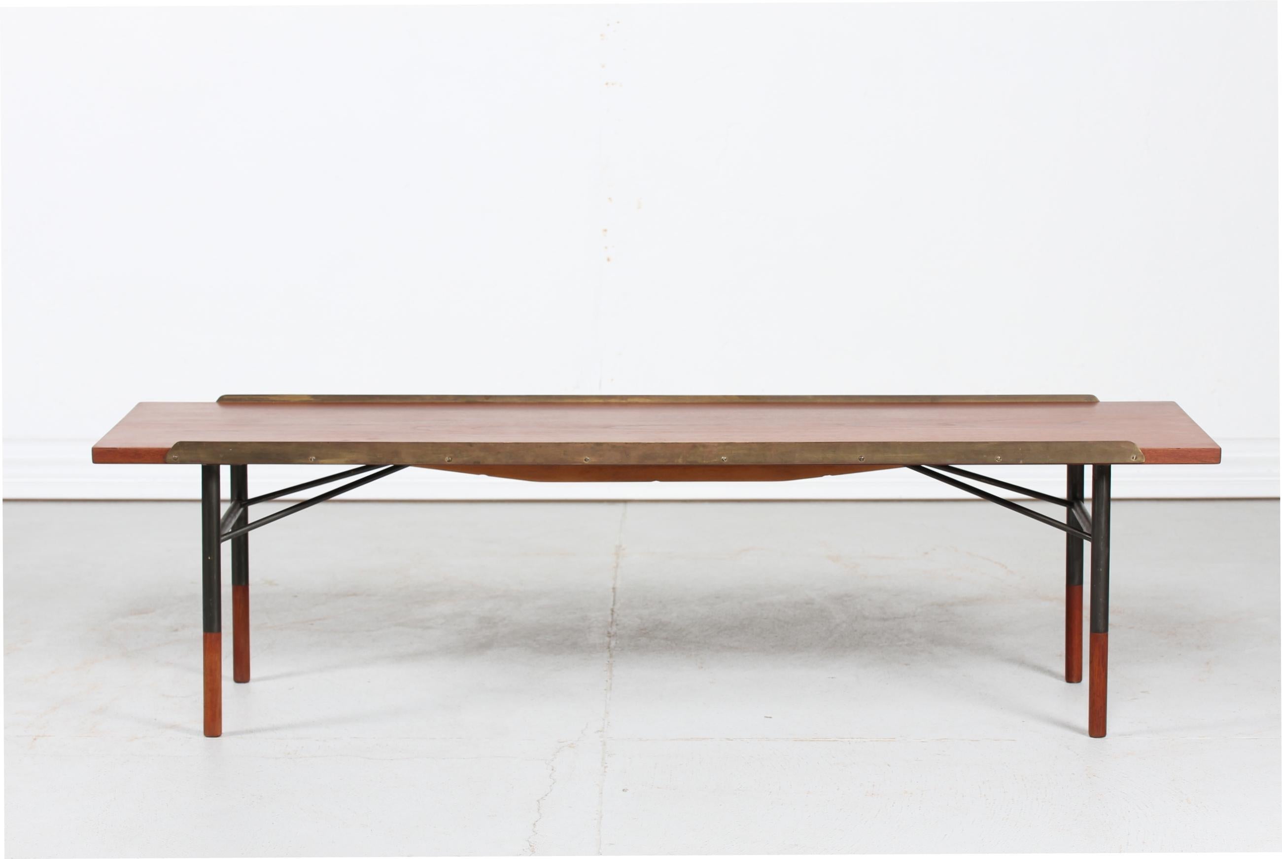 Bench or long table model BO-101 designed by the Danish architect and furniture designer Finn Juhl (1912-1989) in 1953.
It is made of teak with brass edges and metal frame, legs ends of teak
Manufactured by Bovirke in the 1950s. Measures: L