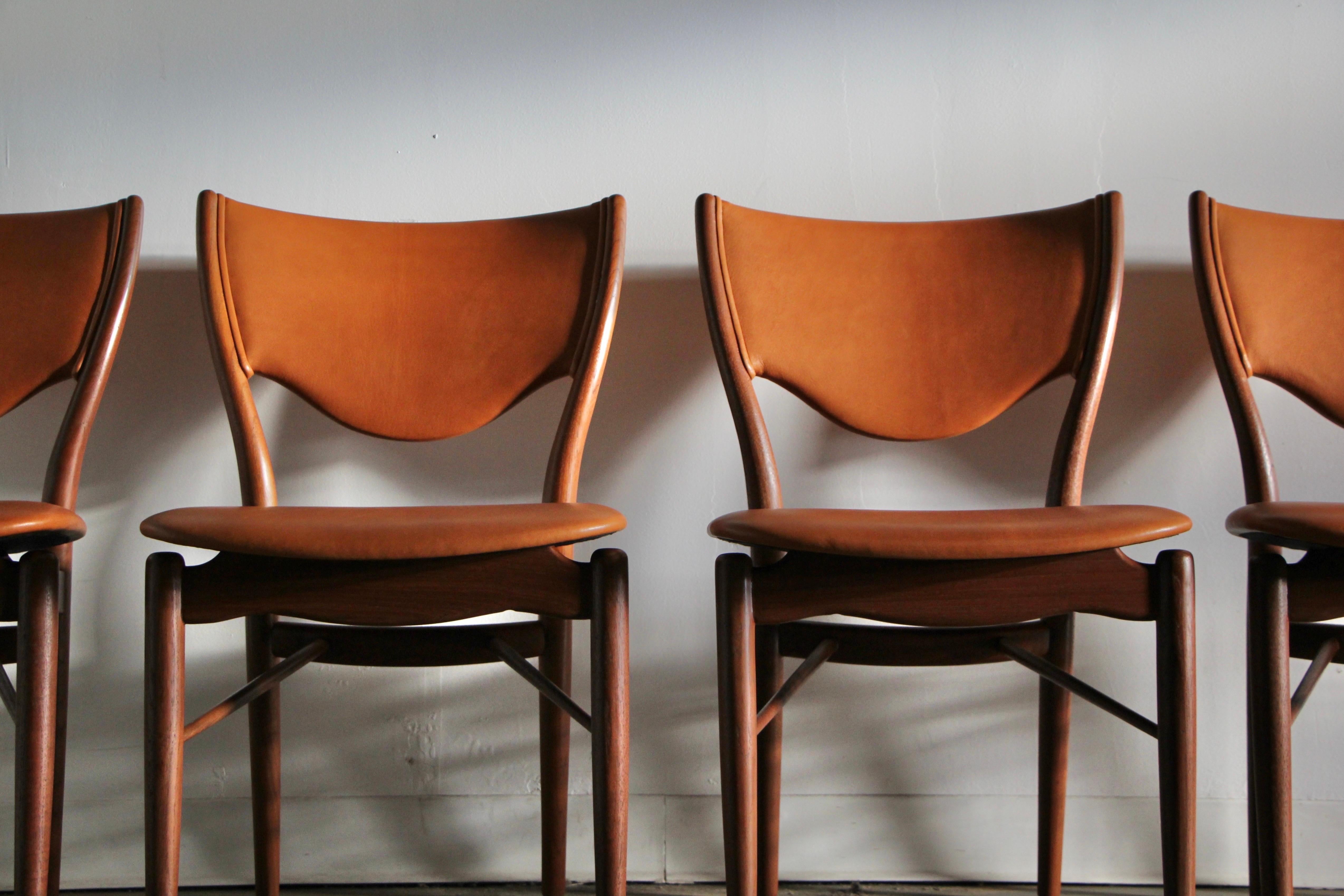 A jaw-dropping set of four Finn Juhl model “BO 63” sculpted teak dining chairs manufactured by Bovirke in the 1950s. This set has been newly and masterfully upholstered in cognac goatskin leather sourced from Italy. the leather will get more and