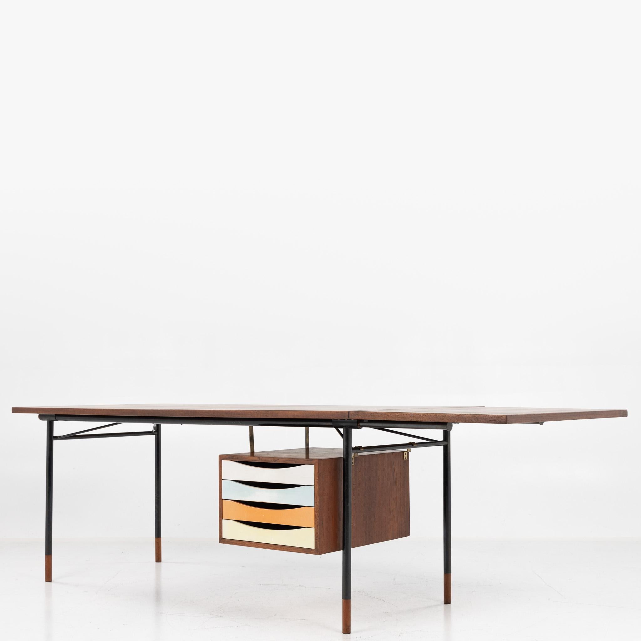 BO 69 - 'Nyhavn' table / desk in teak with oxidised steel frame and drawer module with coloured drawers. Designed by Finn Juhl for Bovirke.
Designed in 1953. Extension plate visible adds an extra 54 cm to the width.
