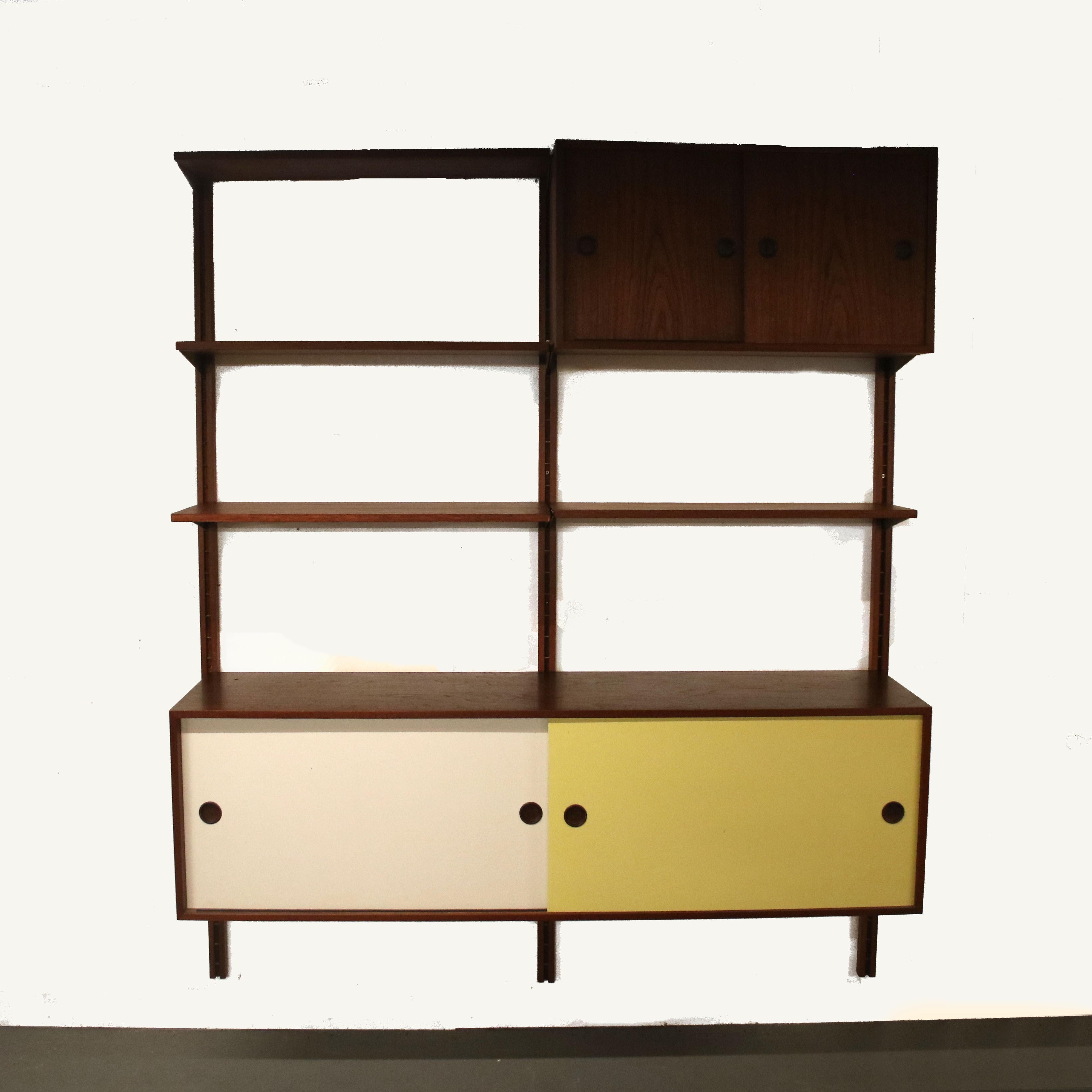 A fantastic wall mounted system cabinet, model “BO71”, designed by Finn Juhl and manufactured by Bovirke in Denmark around 1960.

This beautiful piece made of teak wood in a warm brown colour with white and brown laminated sliding doors. It is two