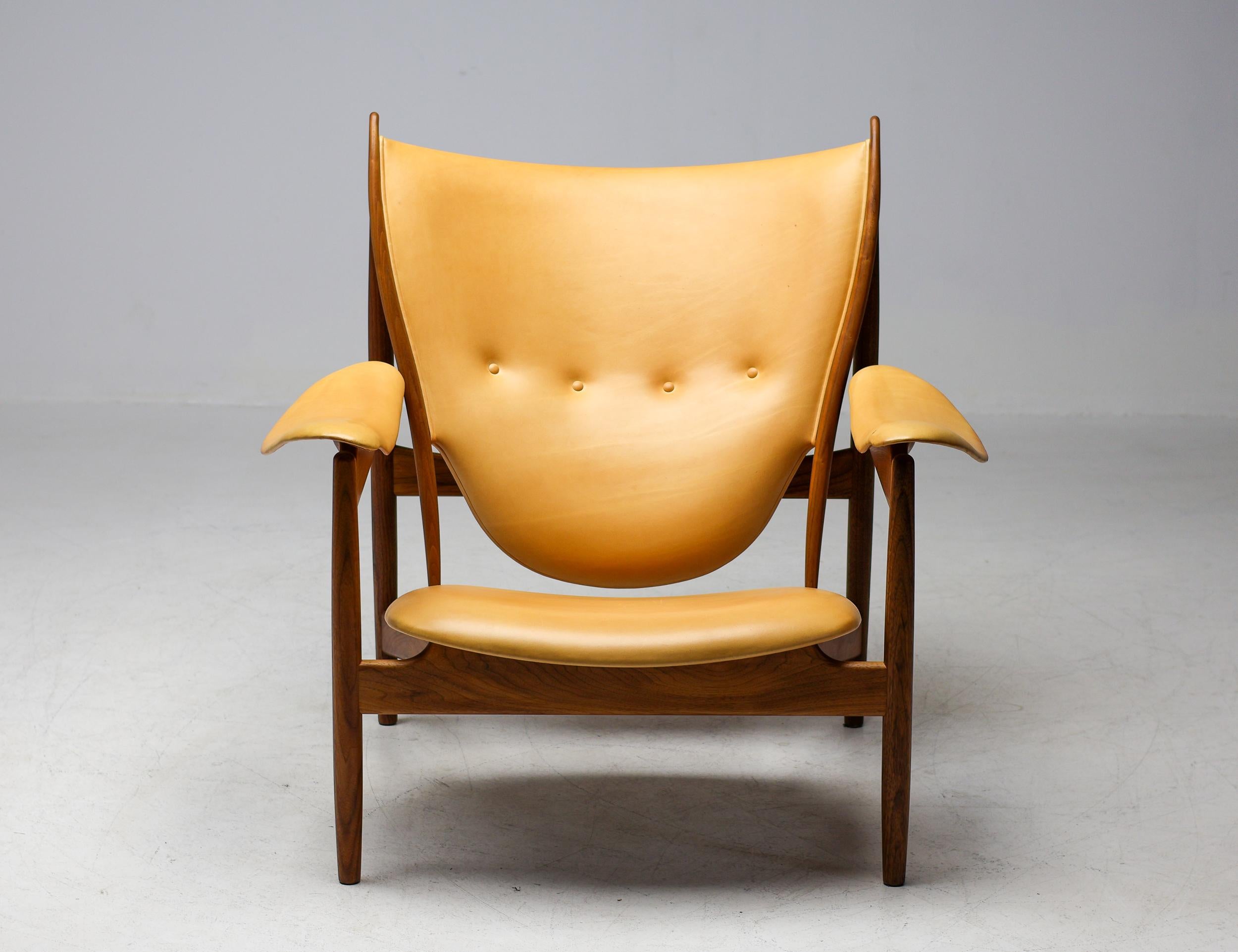 Chieftain Chair designed by Finn Juhl in 1949. This example manufactured by House of Finn Juhl in Denmark in 2015.  Marked with label and signature underneath the chair.
Executed in the most desirable combination of walnut and Vegetal Nature