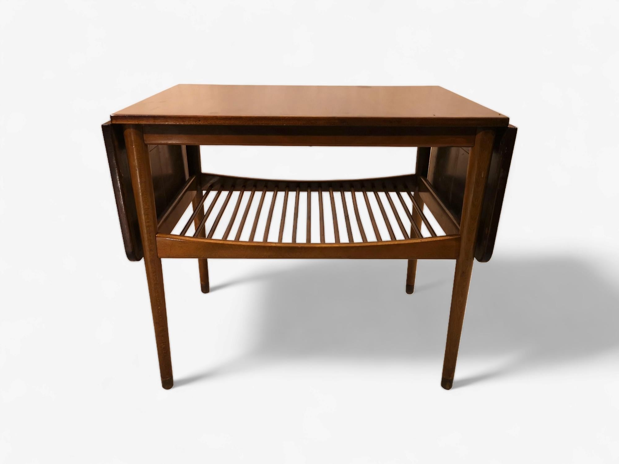 Finn Juhl coffee table with underlying shelf and 2 extensions. 
The table top is walnut, the frame, the legs are made of beech and the legs are finished with brass shoes.

Length with both extension out 124 cm