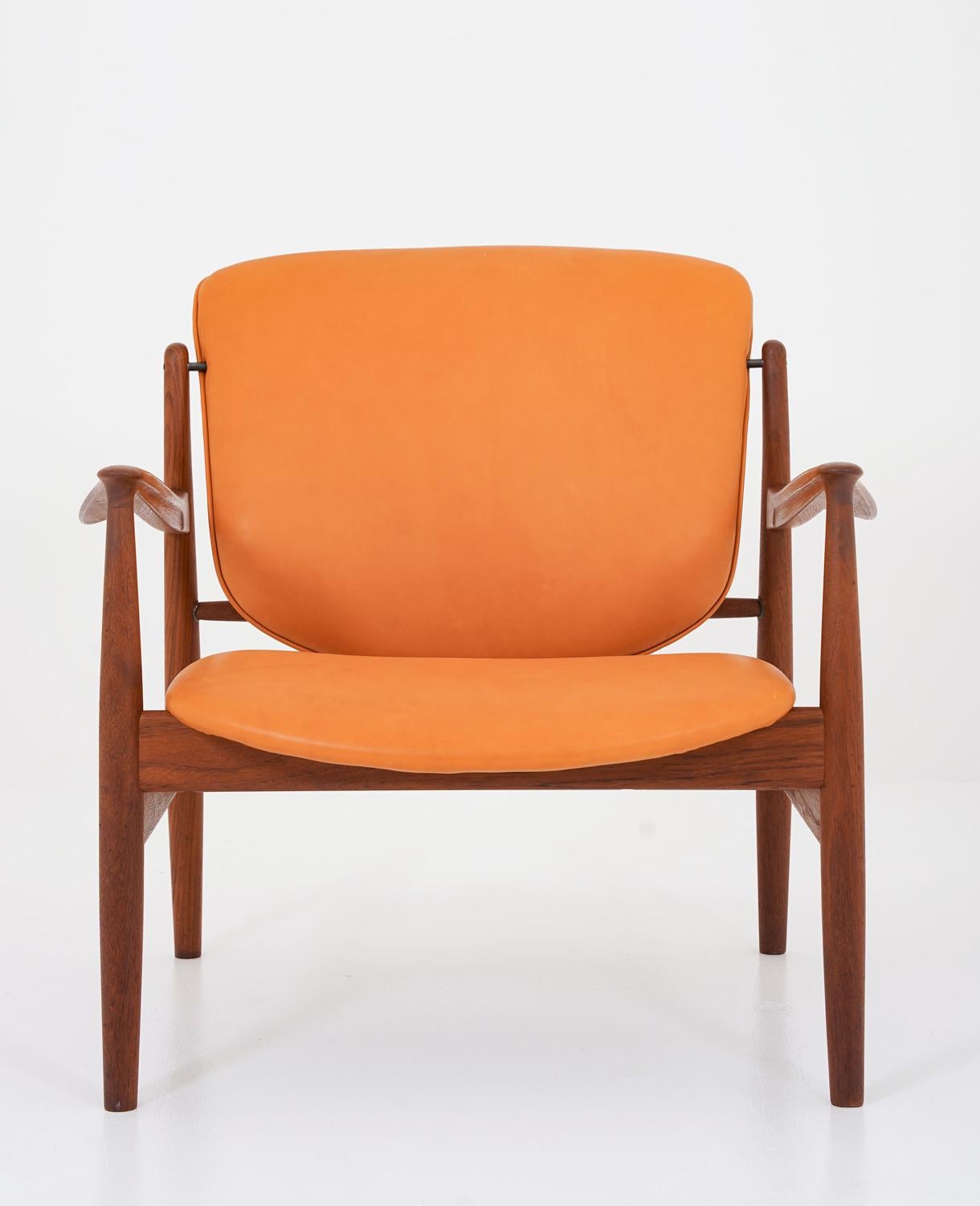 Beautiful lounge chair model FD 136 by Finn Juhl for France & Daverkosen, Denmark.
This chair is features a beautifully shaped teak frame, supporting pillows in cognac coloured leather. 

Condition: Very good condition with light signs of use. The