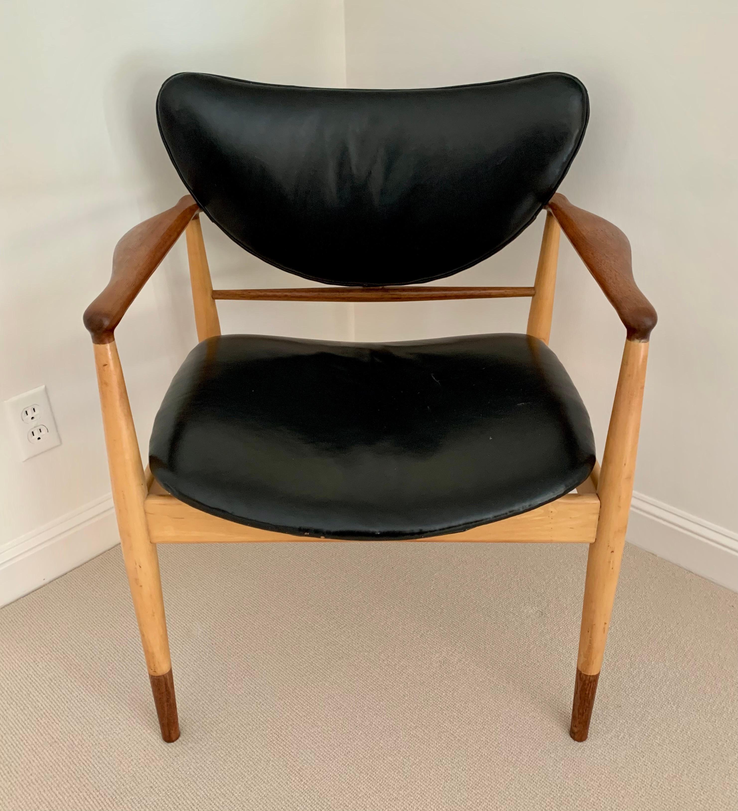 Ultra rare Finn Juhl #48 chair features a maple and walnut two-tone frame. The fabric appears to be leather and has small flaws. It is both elegant and comfortable. Perfect in a dining room or conference room See our other listing for matching chair.