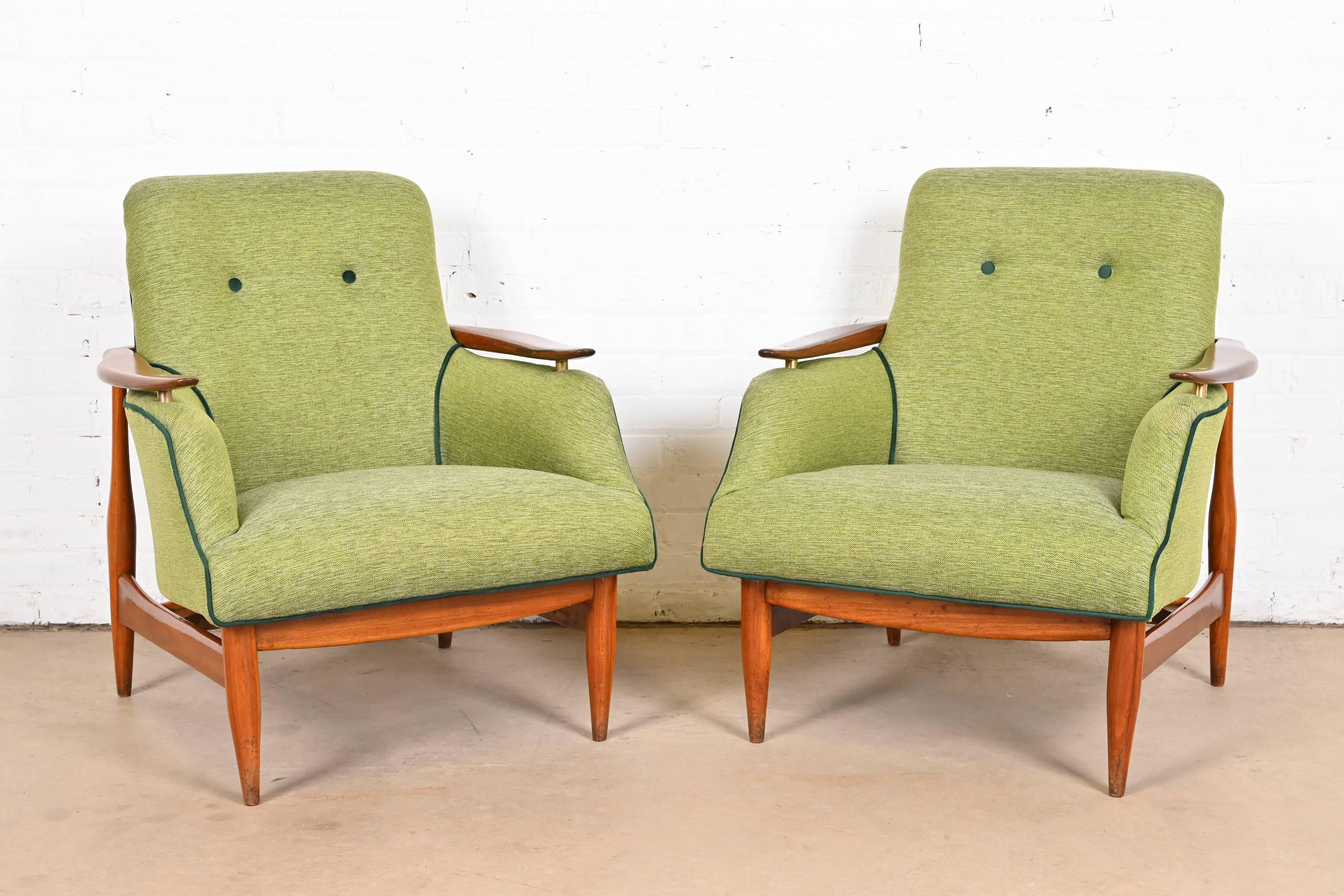 A gorgeous pair of mid-century Danish Modern lounge chairs

Attributed to Finn Juhl

Denmark, 1950s

Sculpted teak frames and brass accents, with green upholstered seats and tufted backs.

Measures: 27