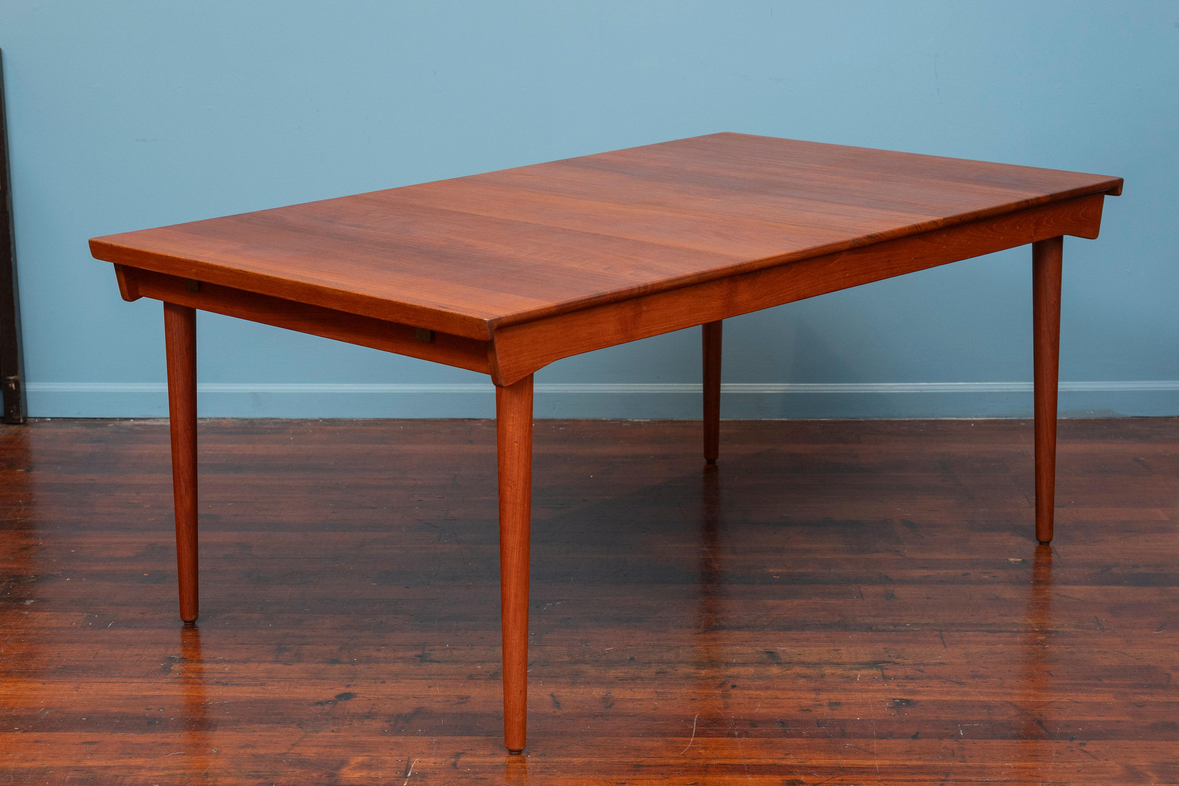 Finn Juhl design extension dining table for France & Son, Denmark. Made with solid teak using high quality Danish cabinetry techniques. Newly refinished and ready to install, the table is gorgeous and ready to last another lifetime. Including two