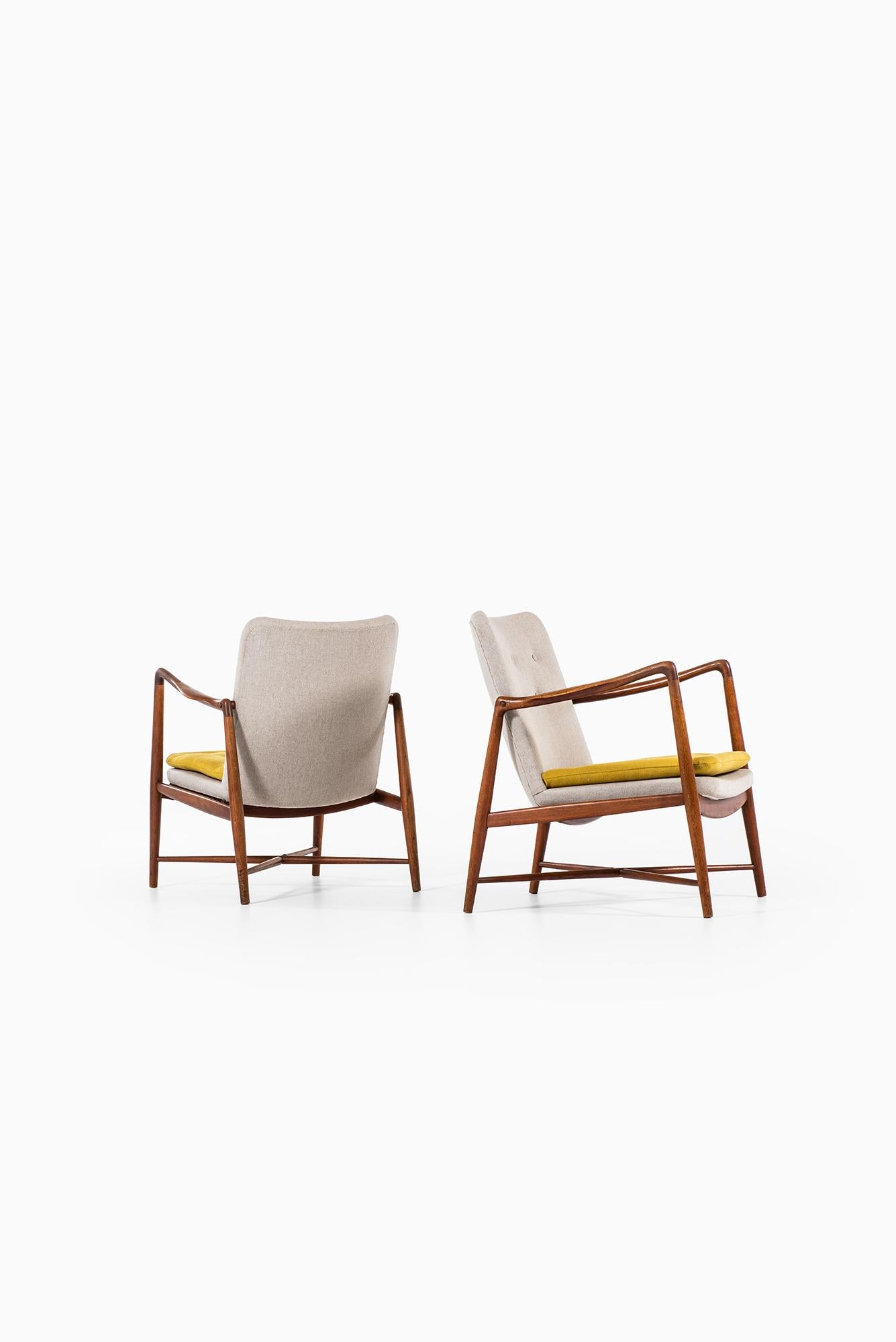 Rare pair of easy chairs model BO59/ fireplace chair designed by Finn Juhl. Produced by Bovirke in Denmark. Teak and newly reupholstered in grey and yellow fabric.