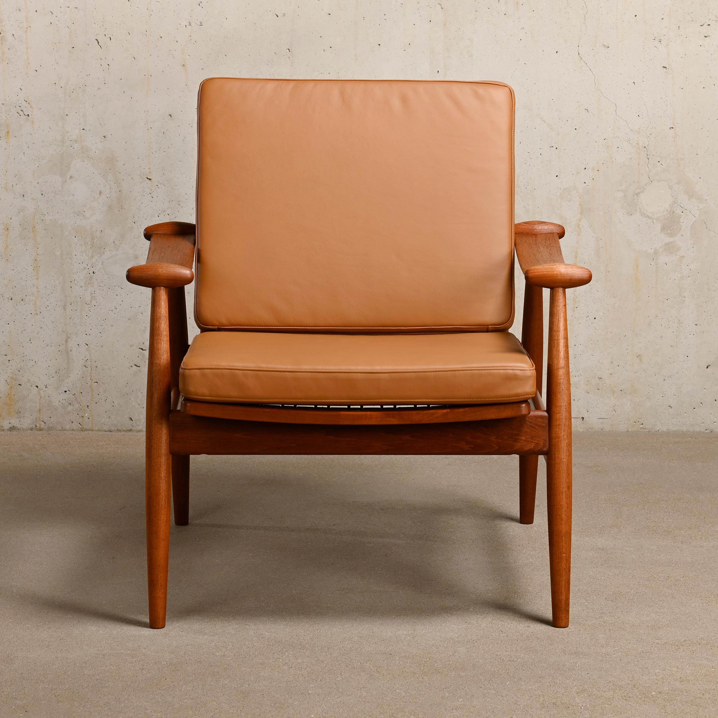 Elegant Easy Chair Model 133 designed by Finn Juhl for France & Daverkosen in 1953, Denmark. Teak frame with distinguishing thin (plywood) curved armrests. The leather cushions are supported by (coated) springs and easily form to the desired sitting