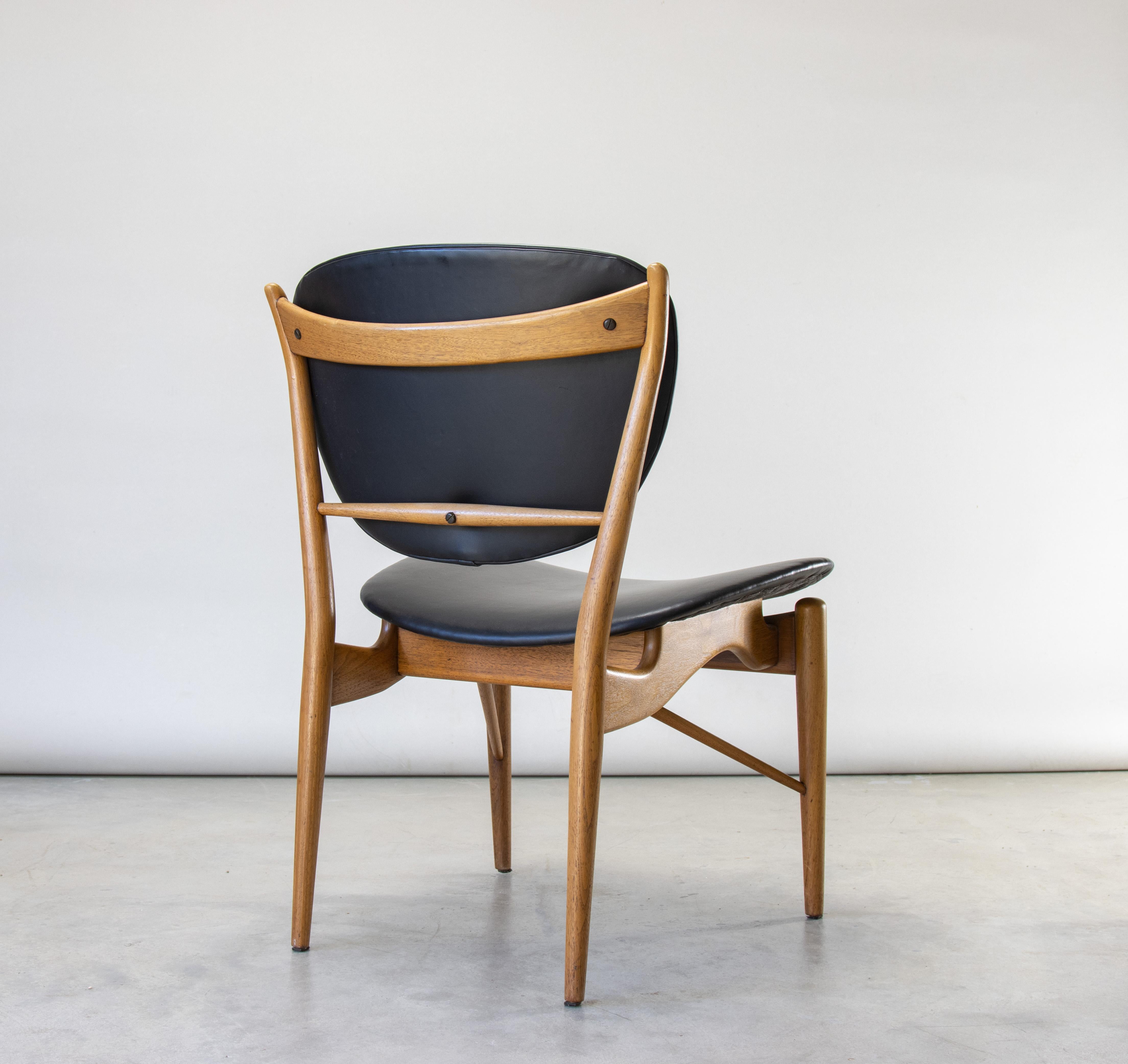 The Finn Juhl 51 chair, produced by Baker Furniture Company in the 1960s. A beautiful example with Finn Juhl’s signature details, including horned tips, exaggerated exposed hardware, angled stretcher,  guitar pick shaped back and floating seat. 