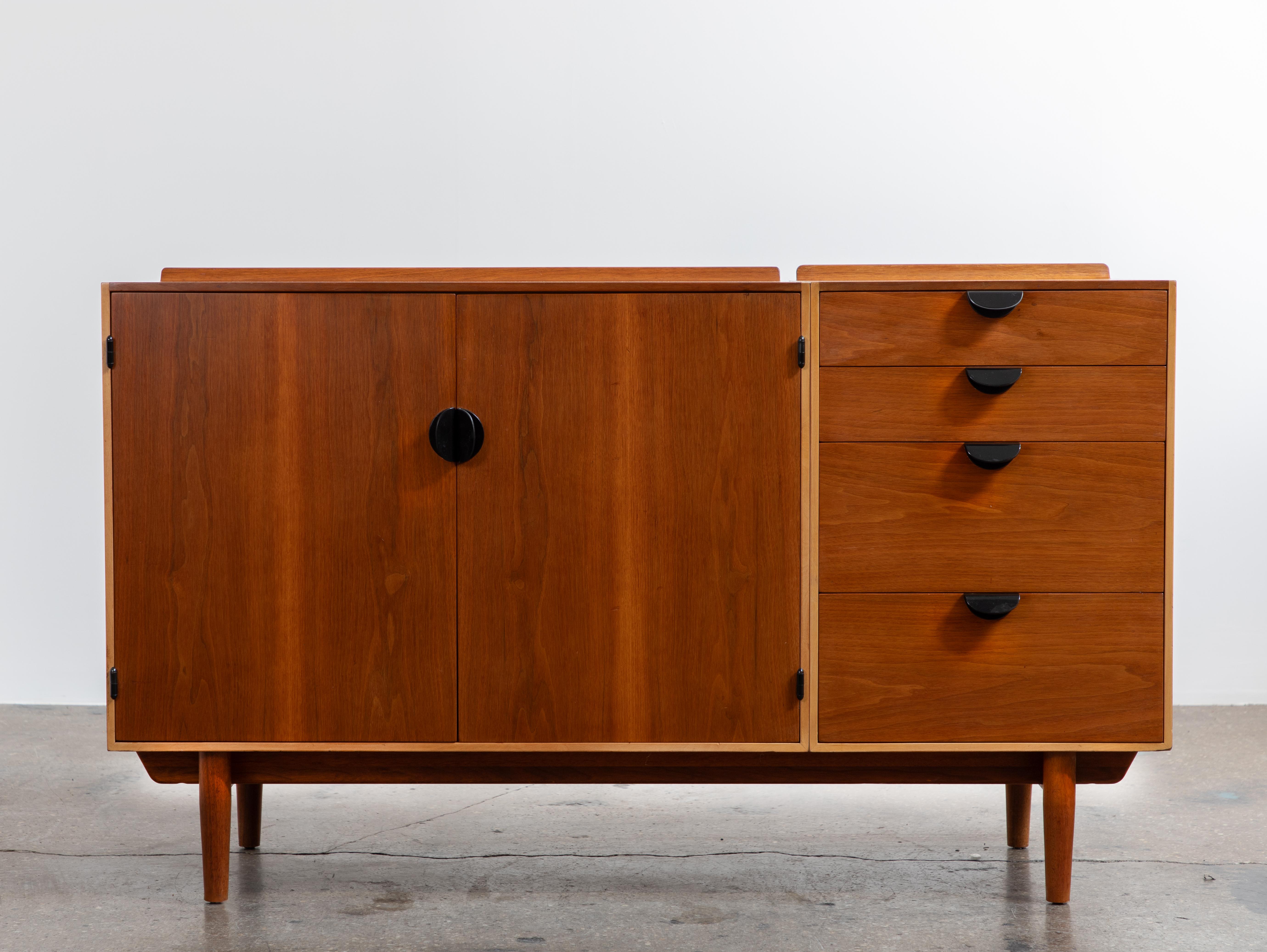 A classic credenza, designed by the architect Finn Juhl for the famed American manufacturer Baker Furniture, as a part of the Baker Modern line. This handsome cabinet features all the hallmarks of the Danish designer,  with its flowing lines,