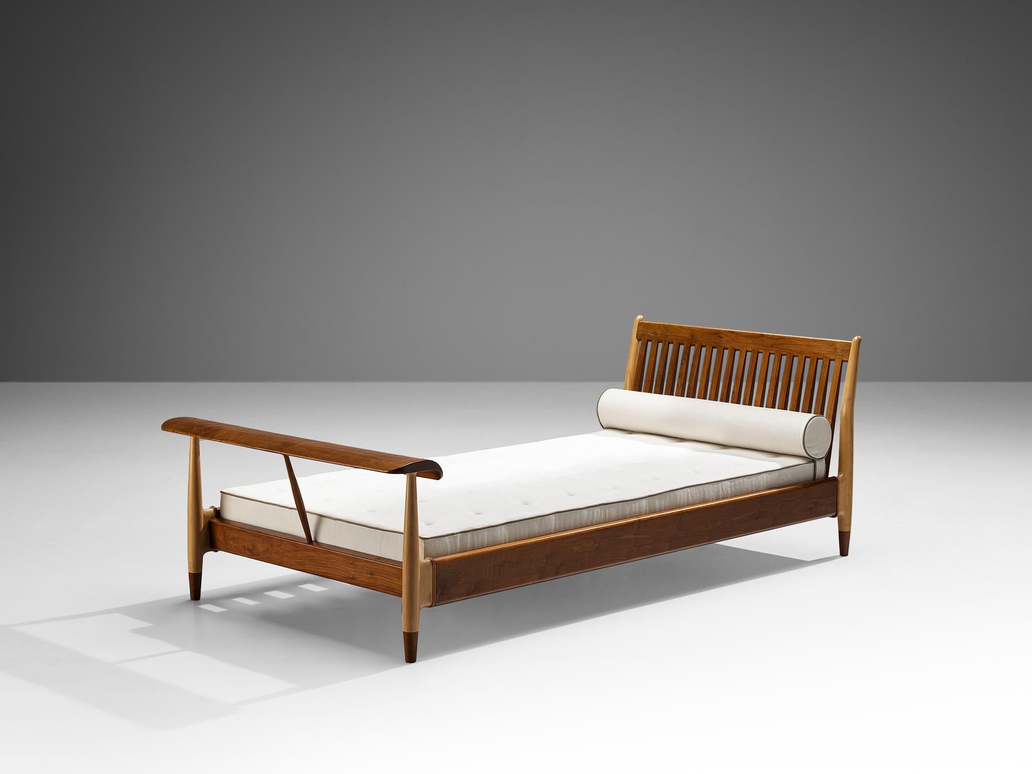 Finn Juhl for Baker Furniture, daybed, walnut, birch, USA/Denmark, ca. 1951

Elegant and beautiful bed designed by Finn Juhl around 1951. This daybed is made from several types of wood which gives its appearance a beautiful contrast. The slatted