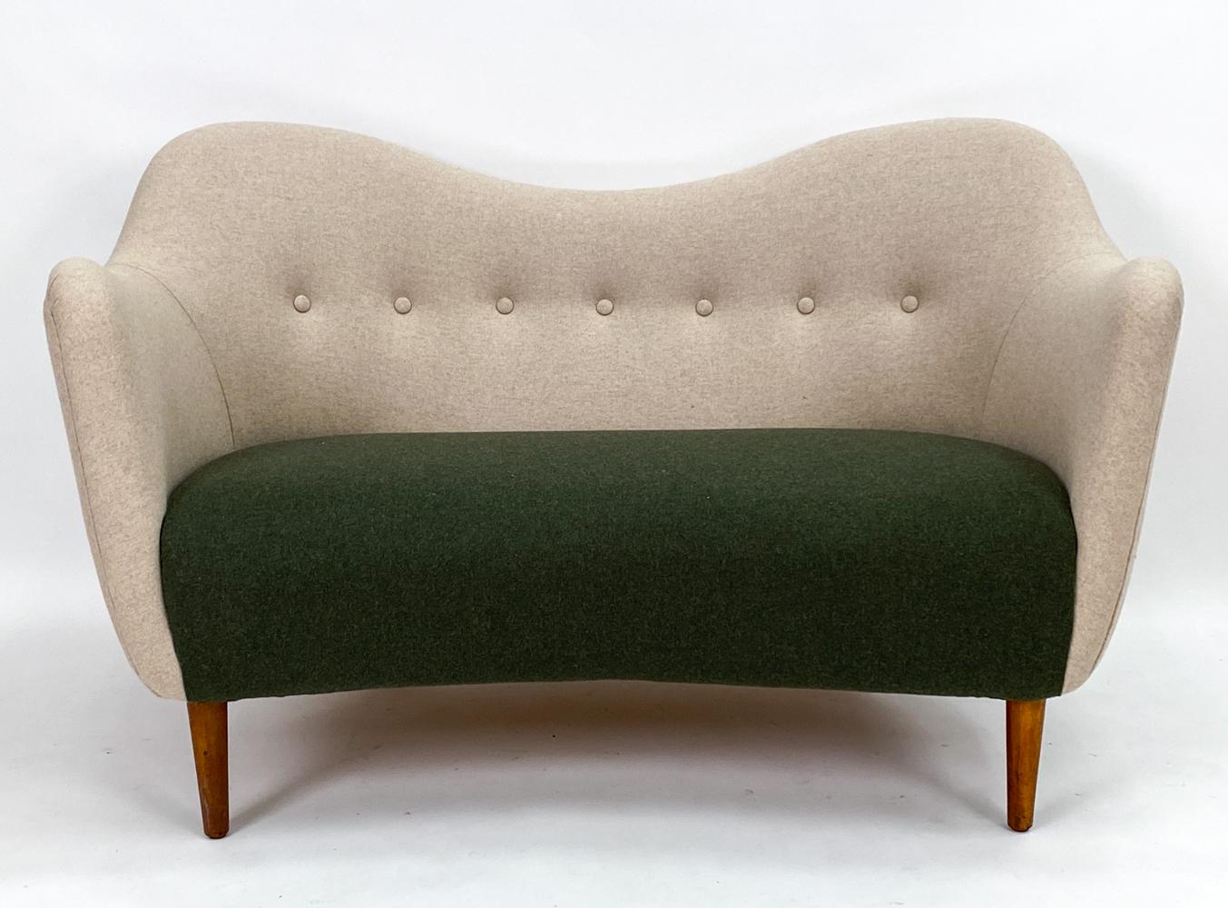 An iconic Danish mid-century sofa from Finn Juhl, one of the early leaders of the Scandinavian modern design movement, this model BO 46 petite proportioned sofa or loveseat was manufactured by Bovirke, c. 1940's. Sculptural, curvilinear lines lend