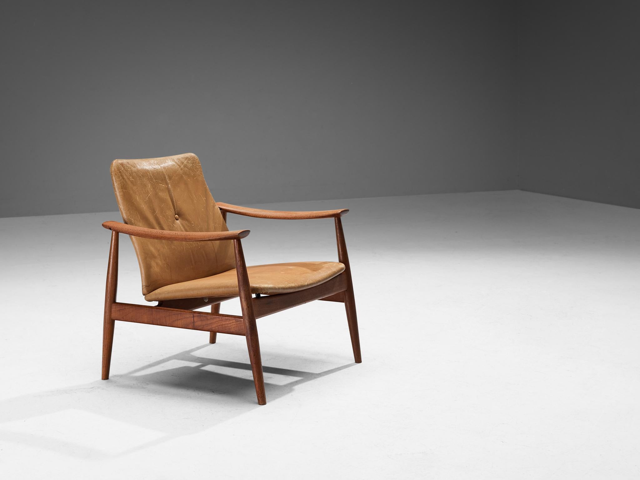 Finn Juhl for France & Søn, no. 138 lounge chair, teak, leather, Denmark, design ca. 1959

This easy chair is designed by Danish master designer Finn Juhl in 1959. Defined by a sleek organic frame in a beautiful teak with its tapered legs guarantees