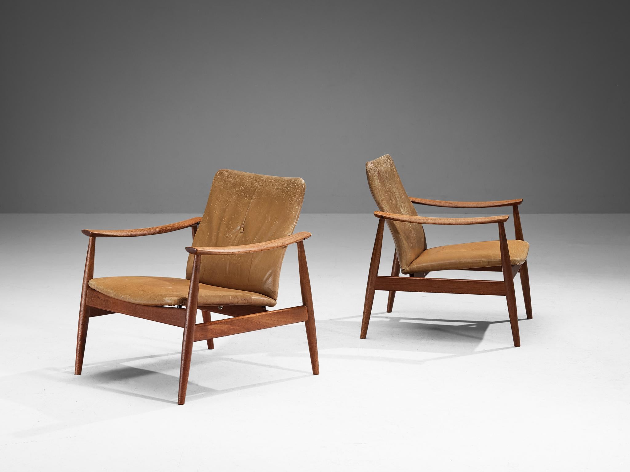 Finn Juhl for France & Søn, pair of no. 138 lounge chairs, teak, leather, Denmark, design ca. 1959

These easy chairs are designed by Danish master designer Finn Juhl in 1959. Defined by a sleek organic frame in a beautiful teak with its tapered