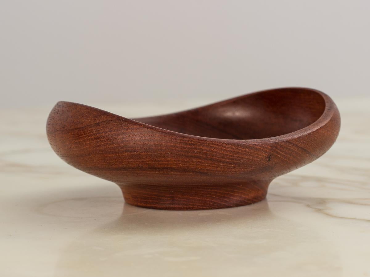Classic Danish modern teak bowls designed by Finn Juhl for Kay Bojesen, Denmark. Turned from a single piece of teak wood into an organic modern shape. Polished and clean, with original patina to the wood. Compact size for everyday functionality, we