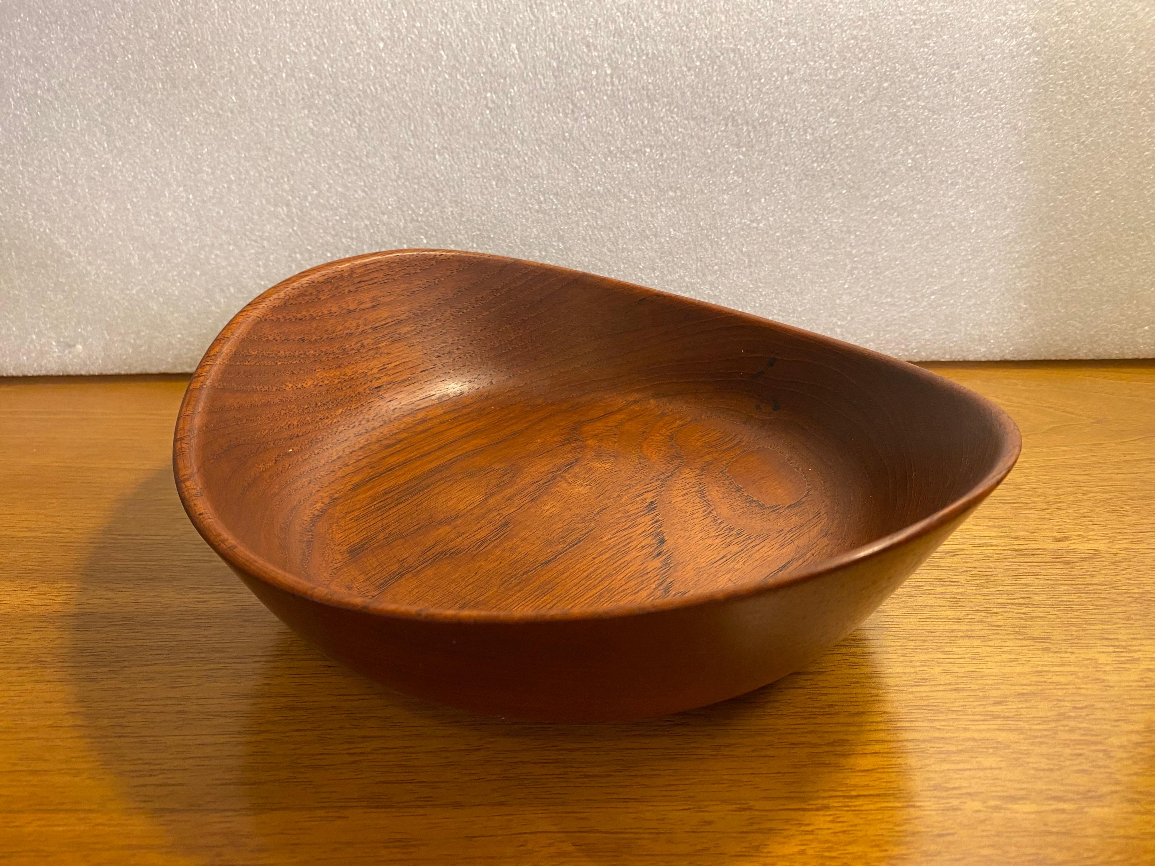 Finn Juhl for Kay Bojesen Teak Footed Bowl.  Finn Juhl designed some of the most beautiful items in the world and his series of turned wood bowls are no exception!  Turned from one piece of teak with 3 cone shaped wood feet.  Raised sculptural edges