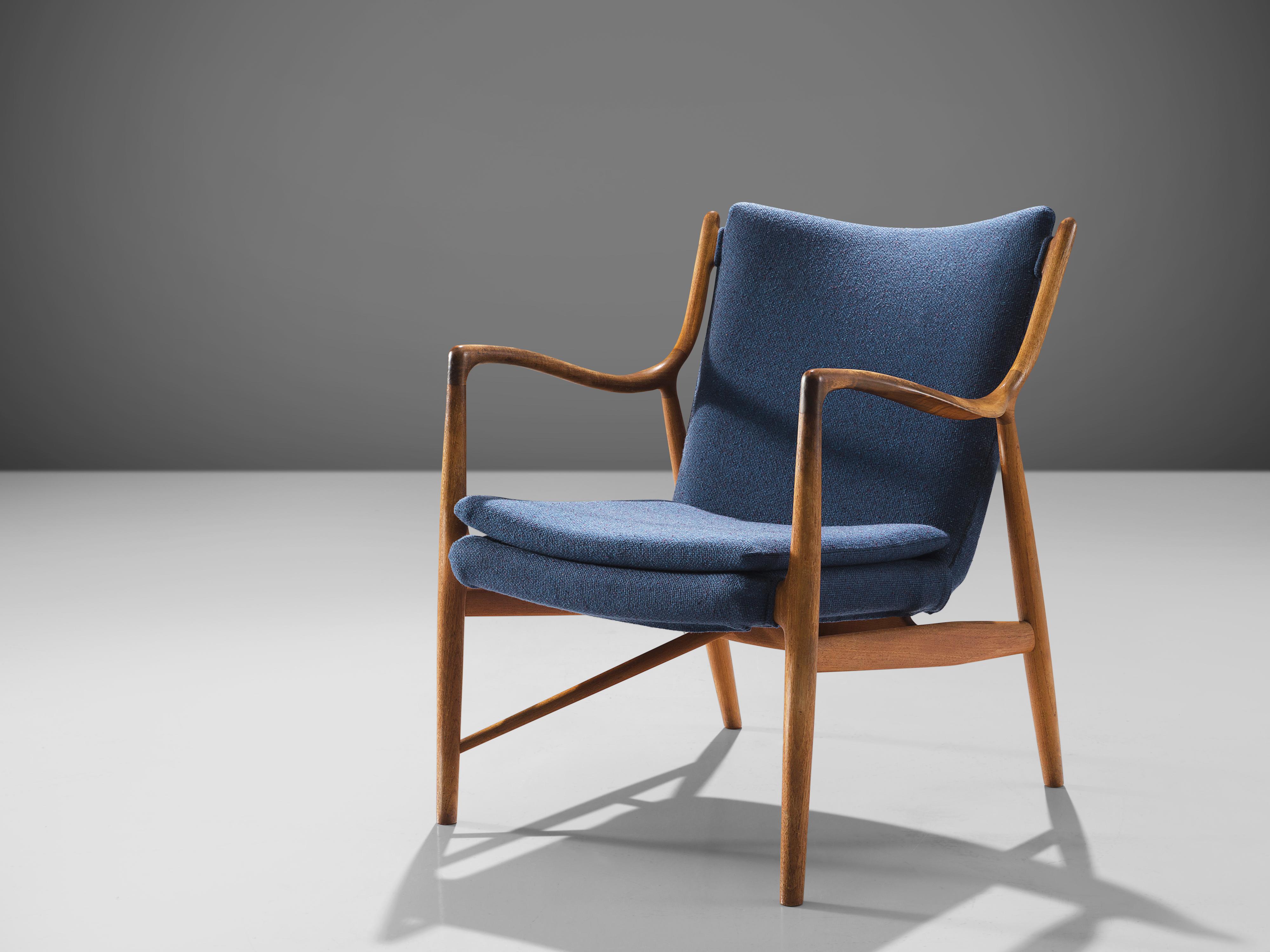 Finn Juhl for Niels Vodder, NV45, teak, blue fabric, Denmark, design 1945, production, 1950s

This ‘NV45’ chair by Finn Juhl is executed in teak and blue fabric. The chair is made by master woodworker Niels Vodder and marked on the inside of the