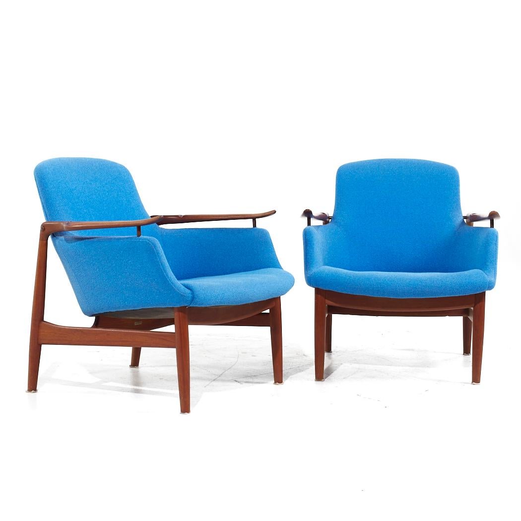Finn Juhl for Niels Vodder NV-53 Blue Chairs - Pair

Each lounge chair measures: 28 wide x 30 deep x 29.5 high, with a seat height of 14.5 and arm height/chair clearance 22.5 inches

All pieces of furniture can be had in what we call restored