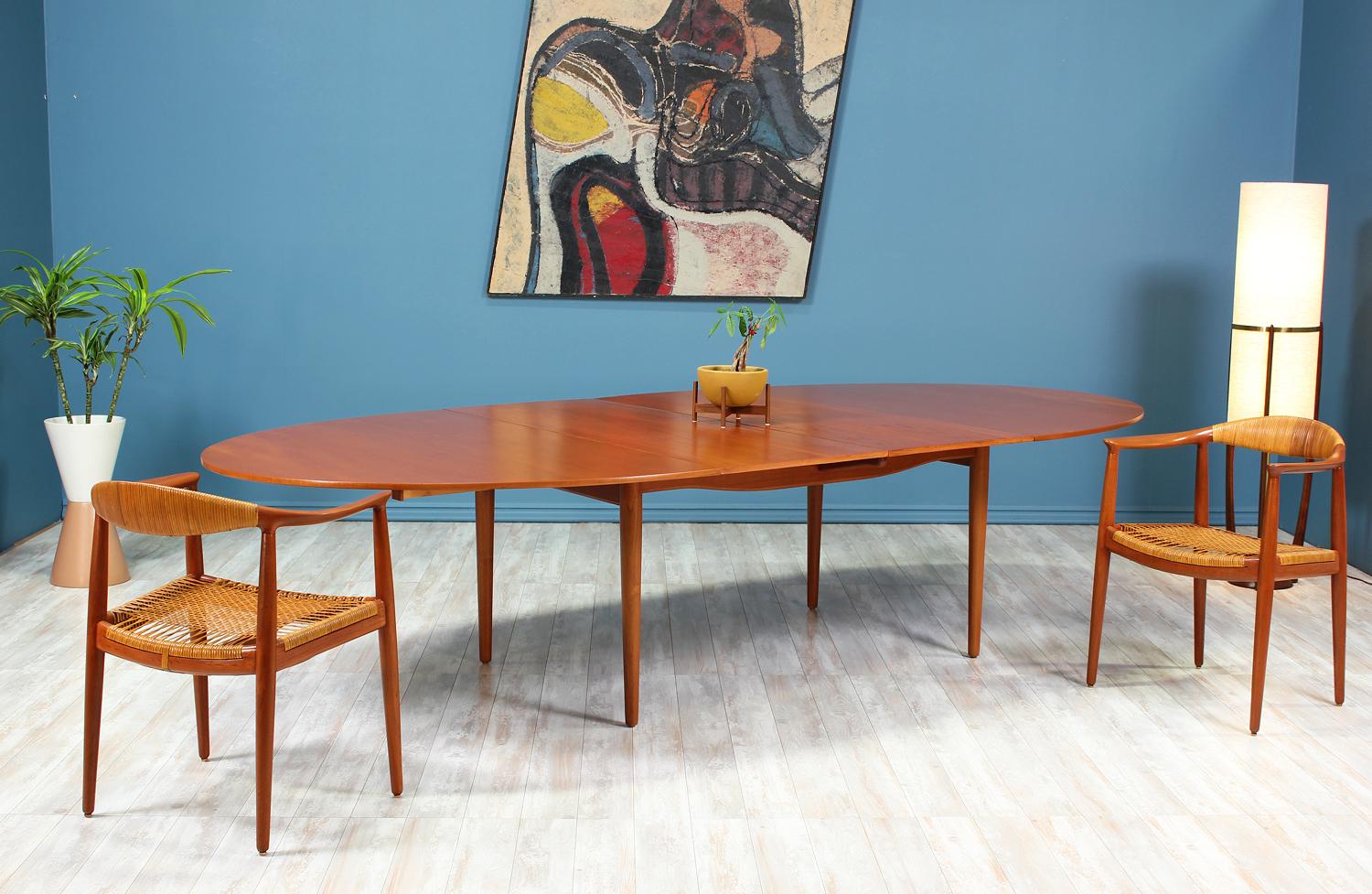 Rare “Judas” dining table designed by Finn Juhl for Baker Furniture Co. in the United States circa 1950’s. This unique design features an oval expandable top with removable leaves allowing more table space when needed. This Baker version, with its