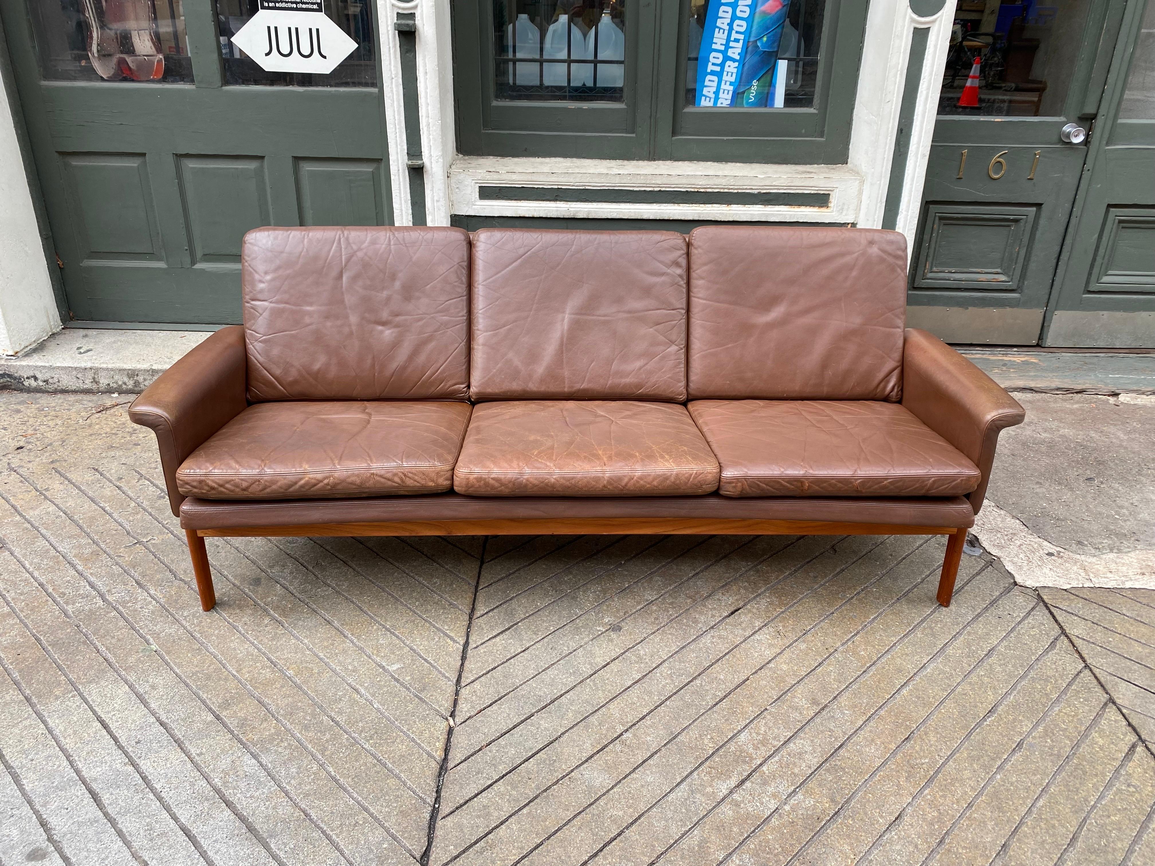 Finn Juhl Jupiter 3 seat brown leather sofa. Shows beautiful Patina and wear! One seat cushion has tear in leather in front as seen in photos, everything else very good. Leather cleaned and waxed! Teak shows nice grain and in nice shape.