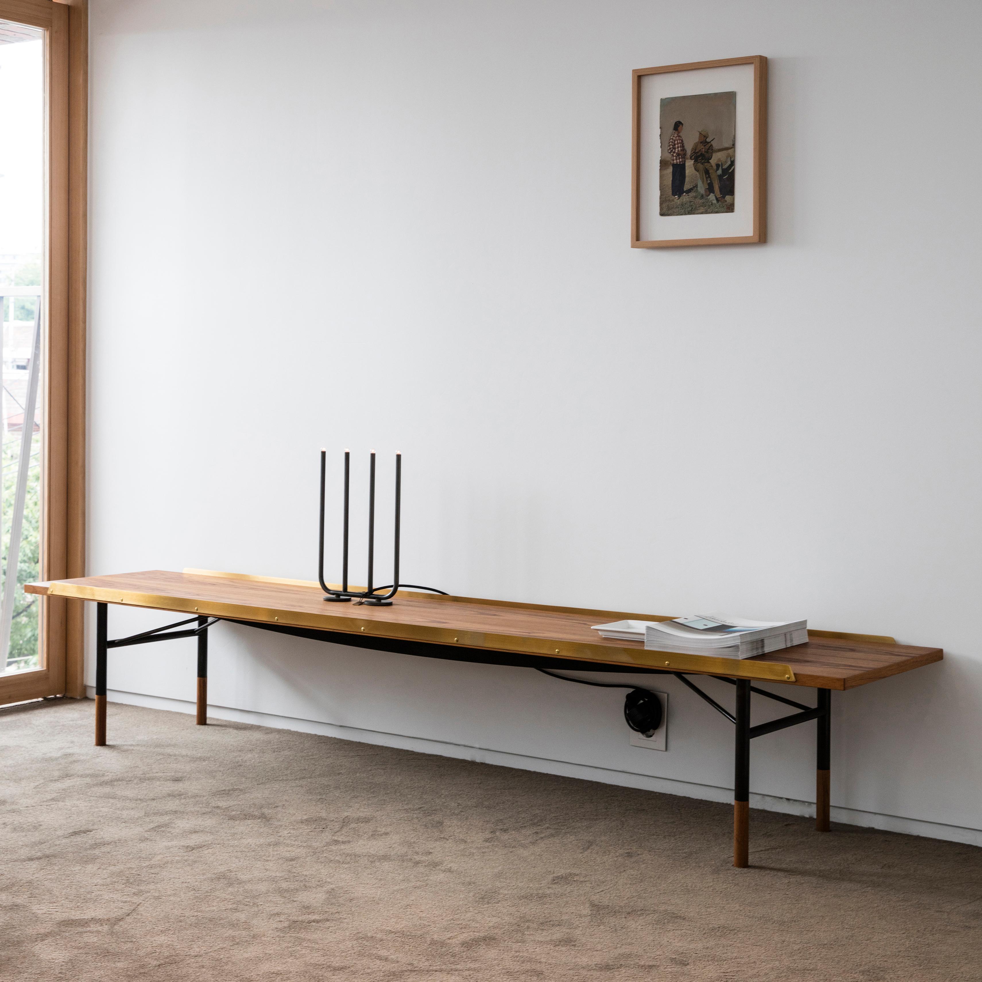 Table bench designed by Finn Juhl in 1953, relaunched in 2012.
Manufactured by House of Finn Juhl in Denmark.

Finn Juhl experienced an international breakthrough in the USA during the early 1950s. He subsequently designed a range of furniture with