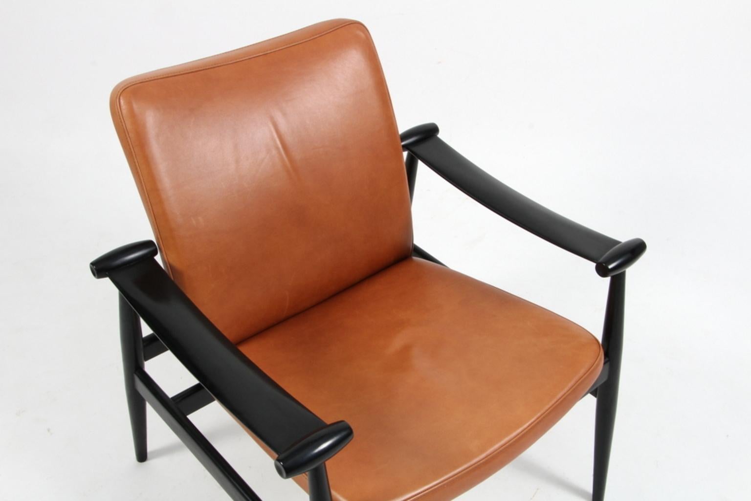 Finn Juhl lounge chair made in black lacquered wood and cognac semi aniline leather.

Model Spade stolen (FD133), made by France & Daverkosen.