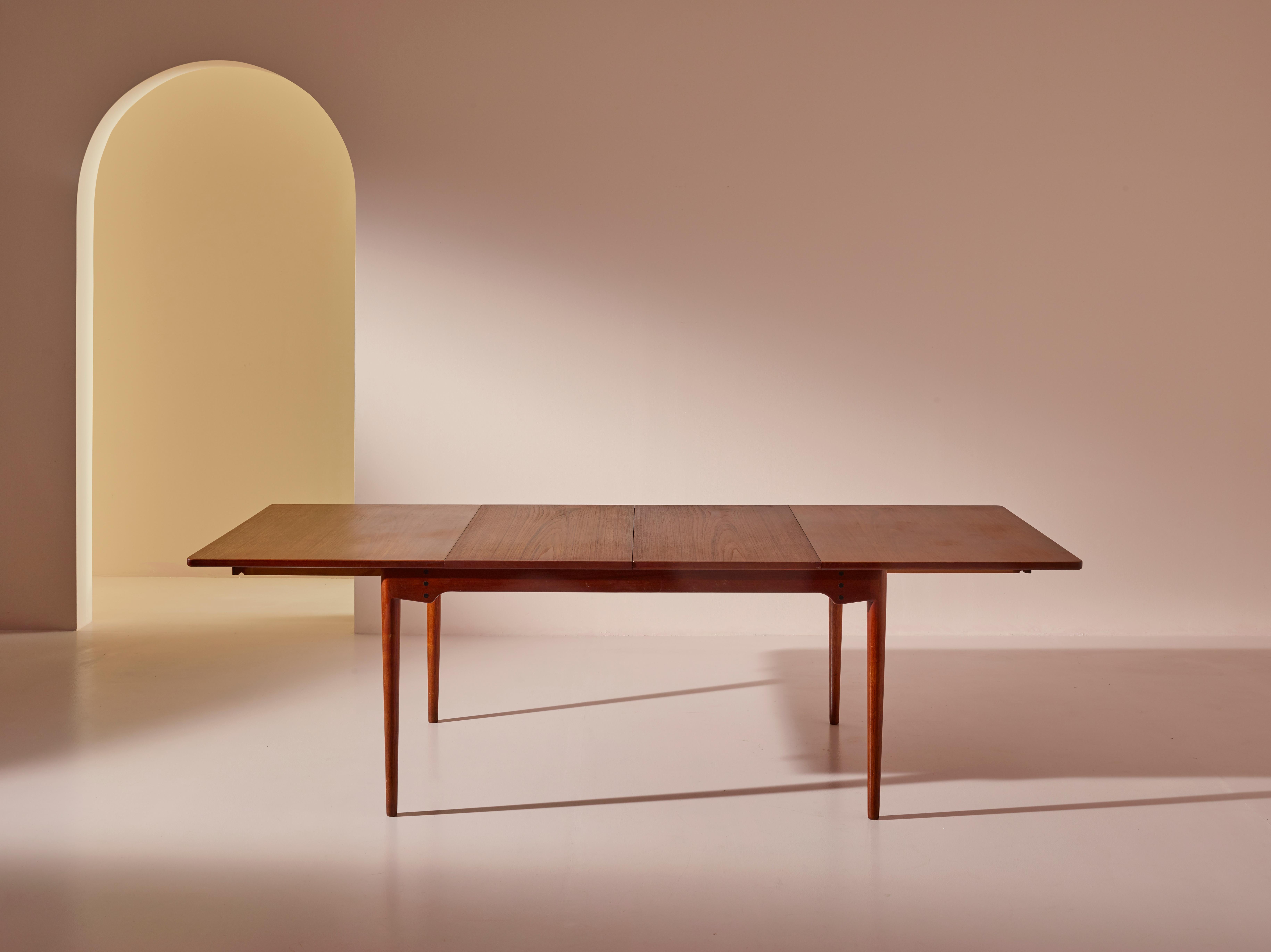 A model BO65 extendable dining table designed by Finn Juhl and manufactured by the Danish cabinetmaker Bovirke. Created in 1952, this model features a sleek and minimalist aesthetic with clean lines, organic shapes, and impeccable craftsmanship.